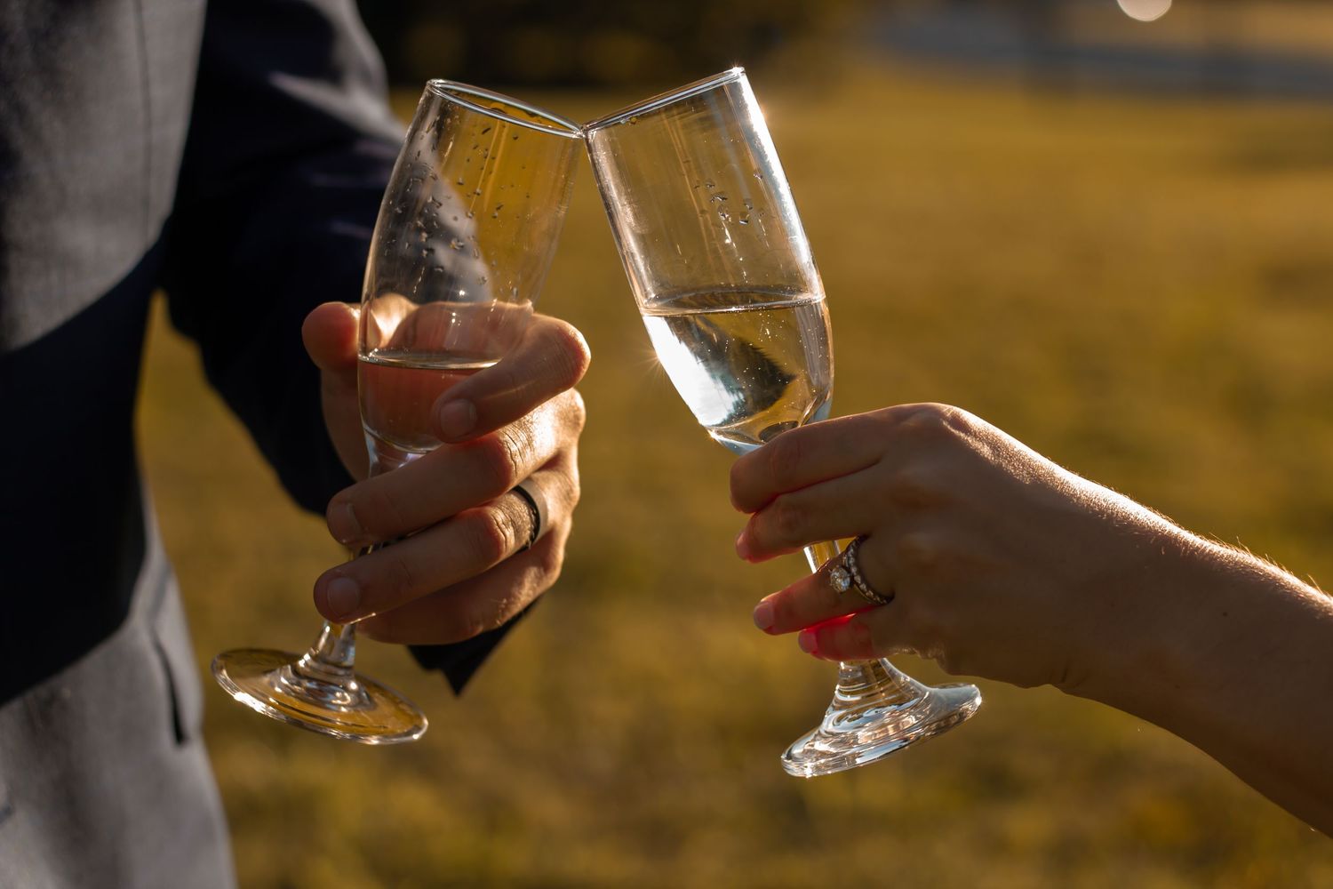 picture of couple cheering each other with their glass wine cups. married at sunset