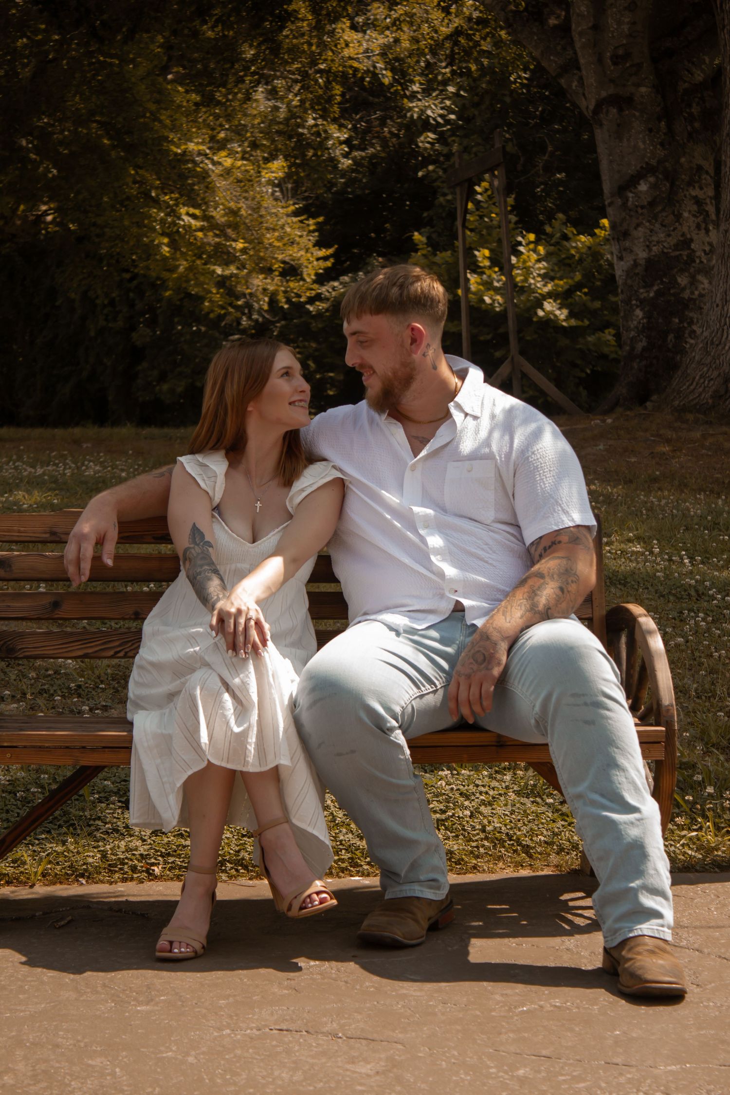 picture of couples sitting on bench and they're looking at each other