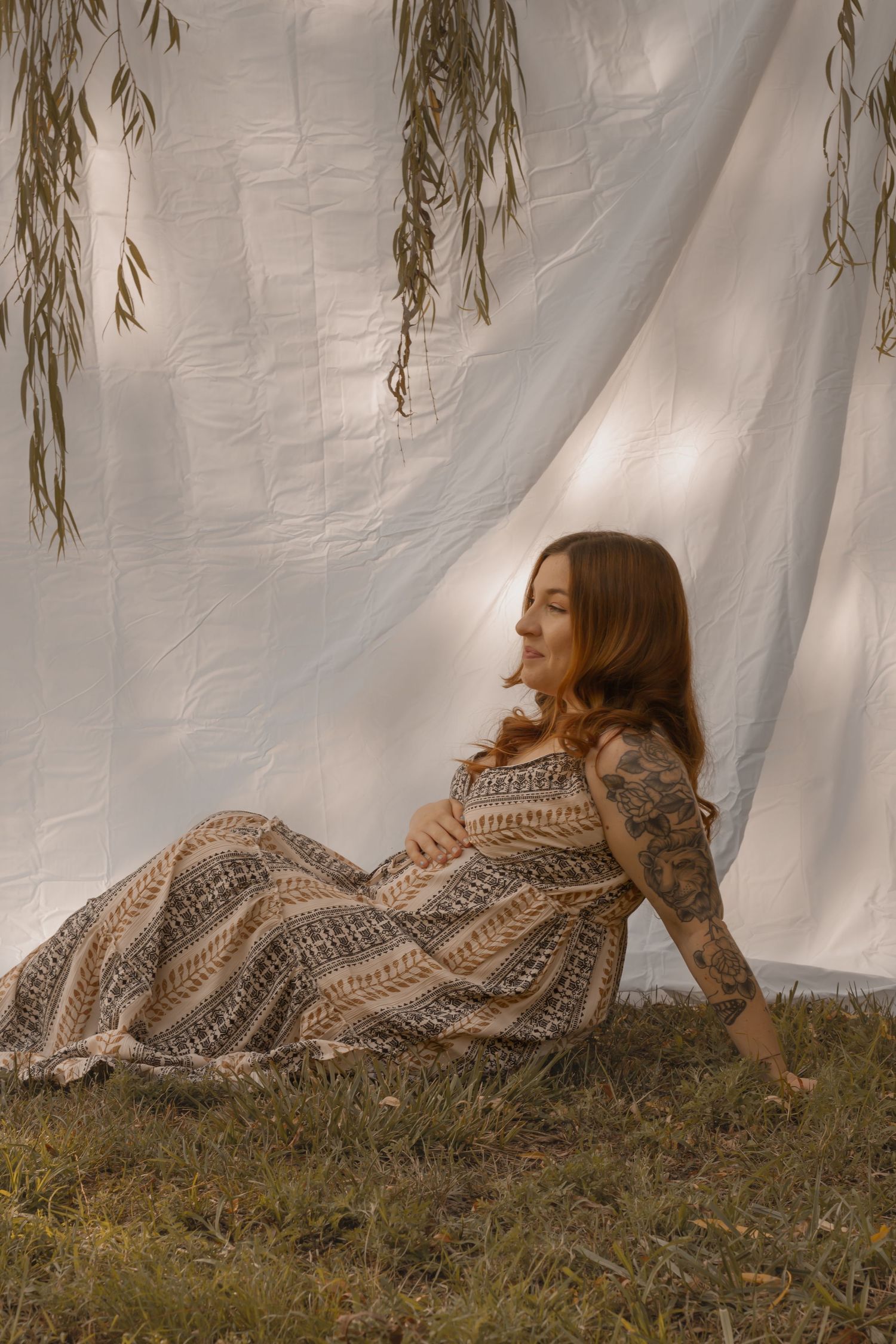 picture of mama to be laying down on the side looking away.