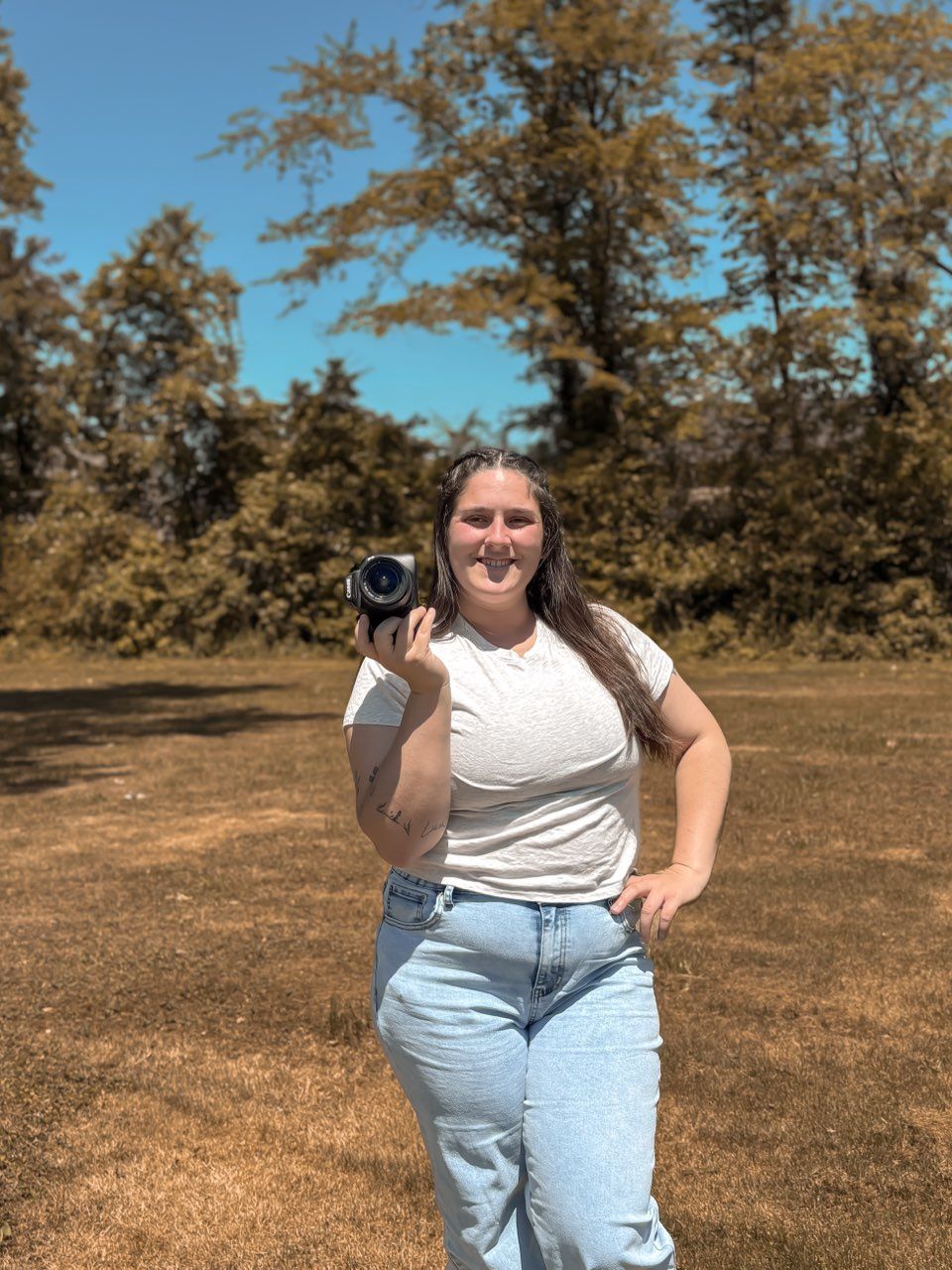 picture of amber dunnigan in forest, holding camera