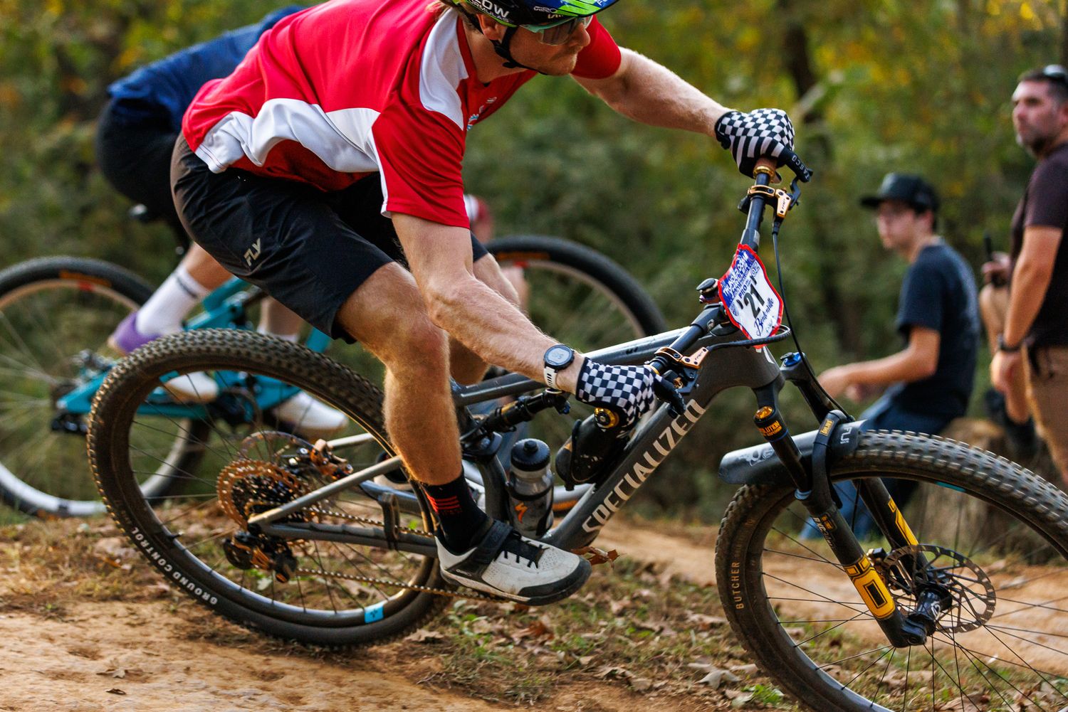 Close-up of mountain biker on Specialized bike navigating technical trail section.