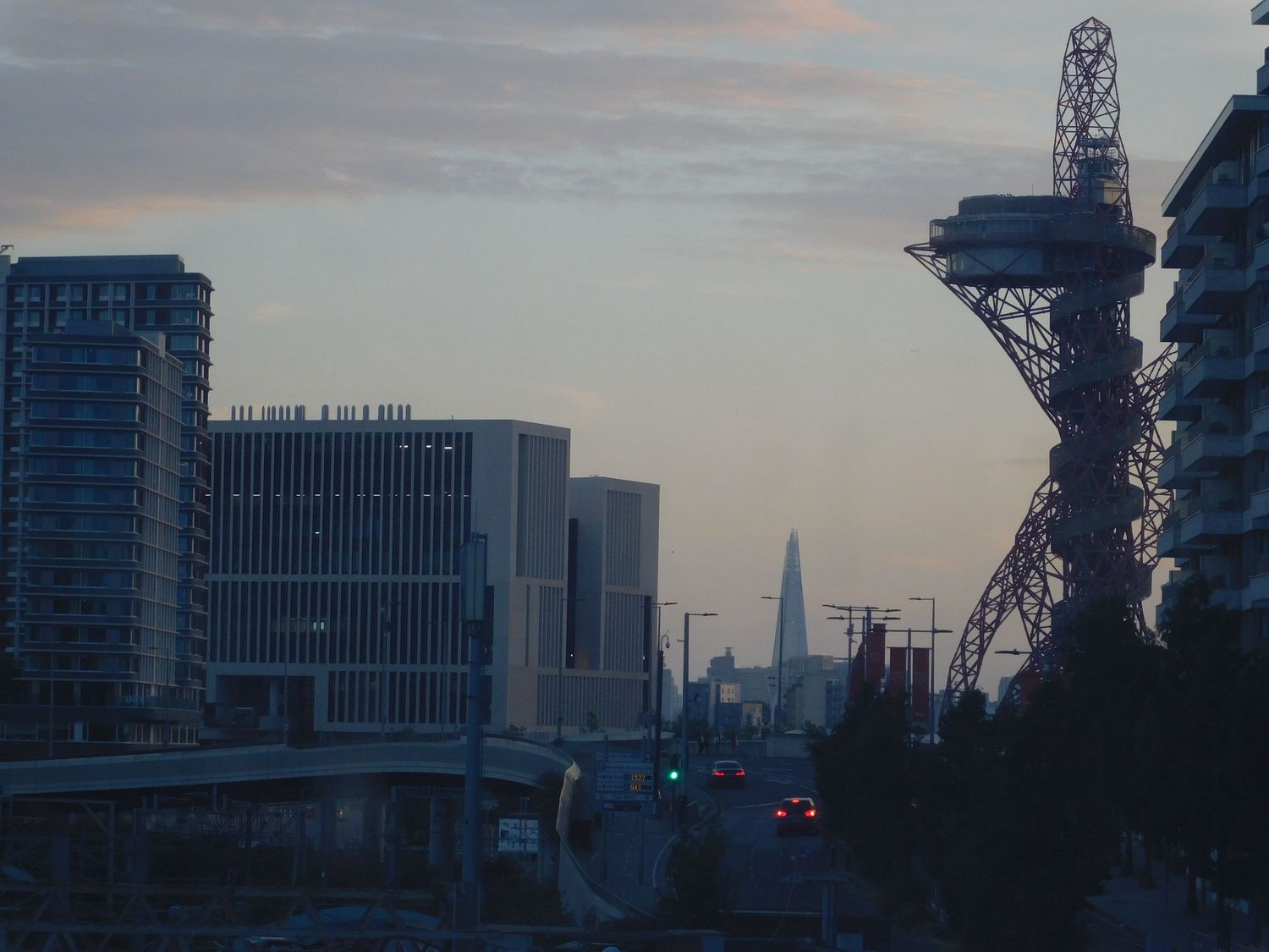 London skyline at dusk featuring The Shard and ArcelorMittal Orbit tower at Olympic Park.