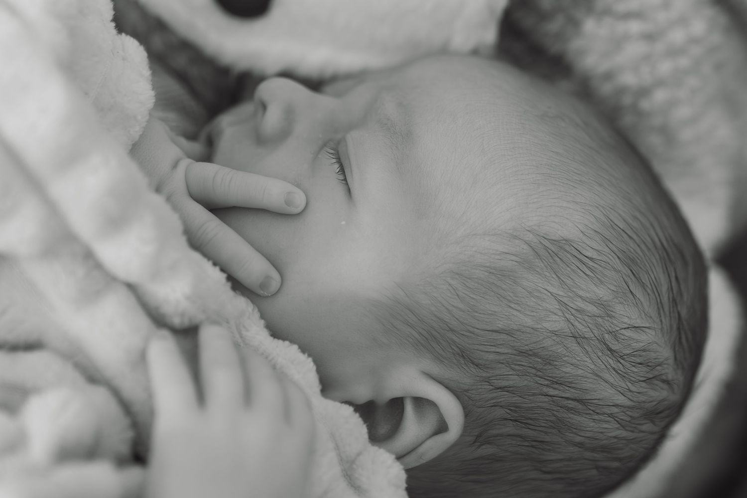 Newborn baby sleeping during candid photography session at home in Dorset, UK