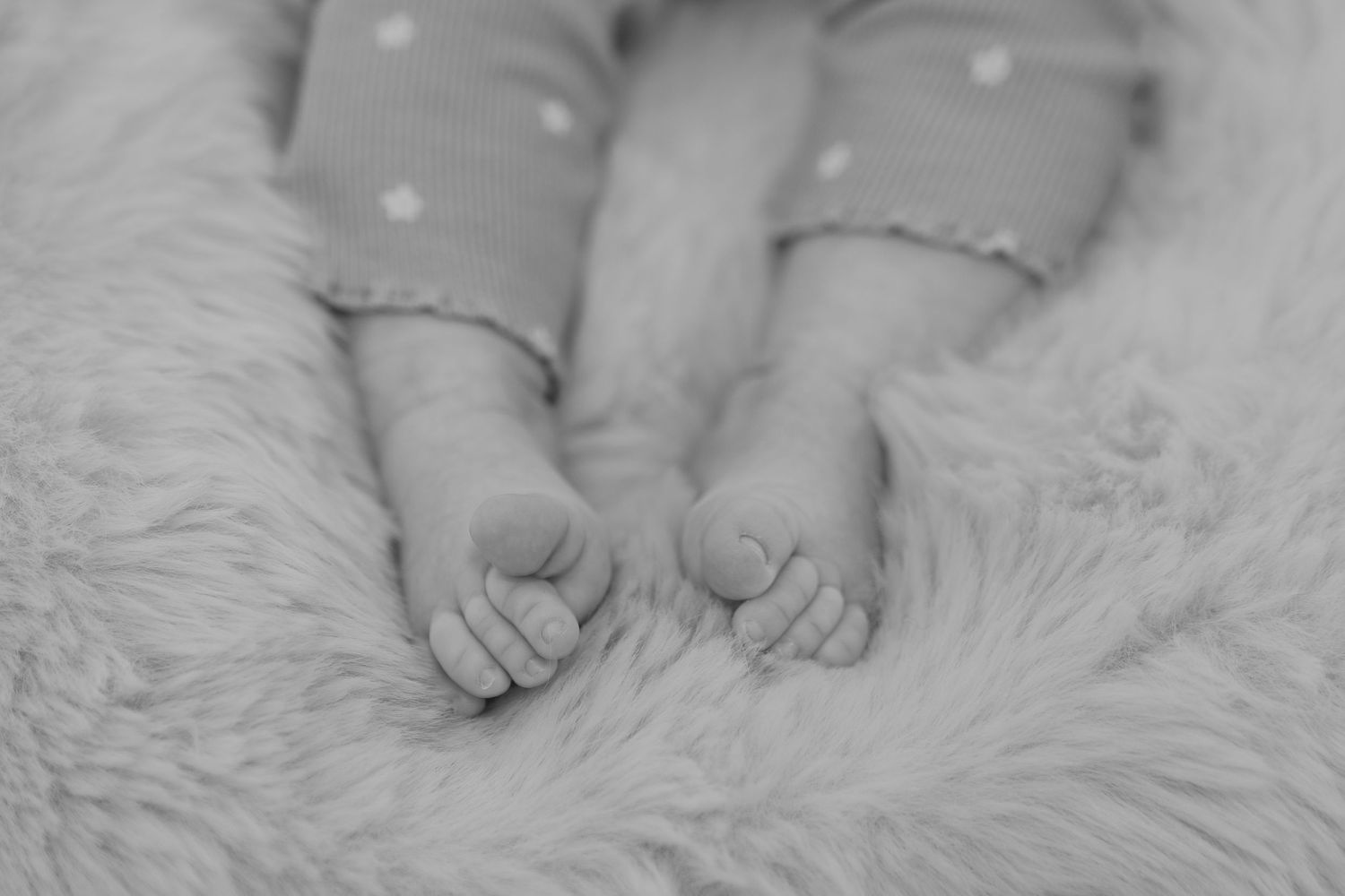 Close up detail of baby's feet during a photoshoot at home