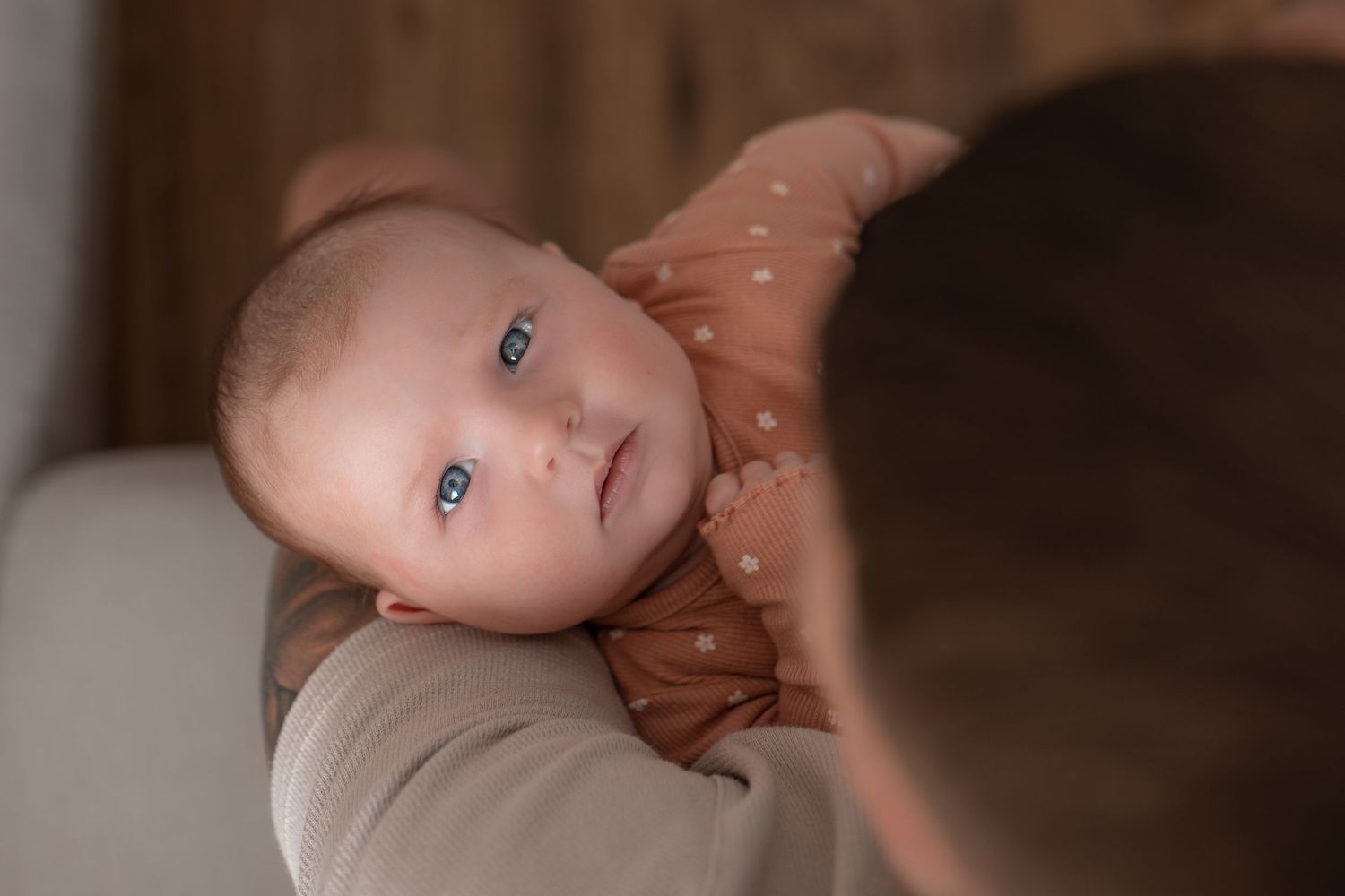 Baby looking at the camera during newborn photoshoot at home