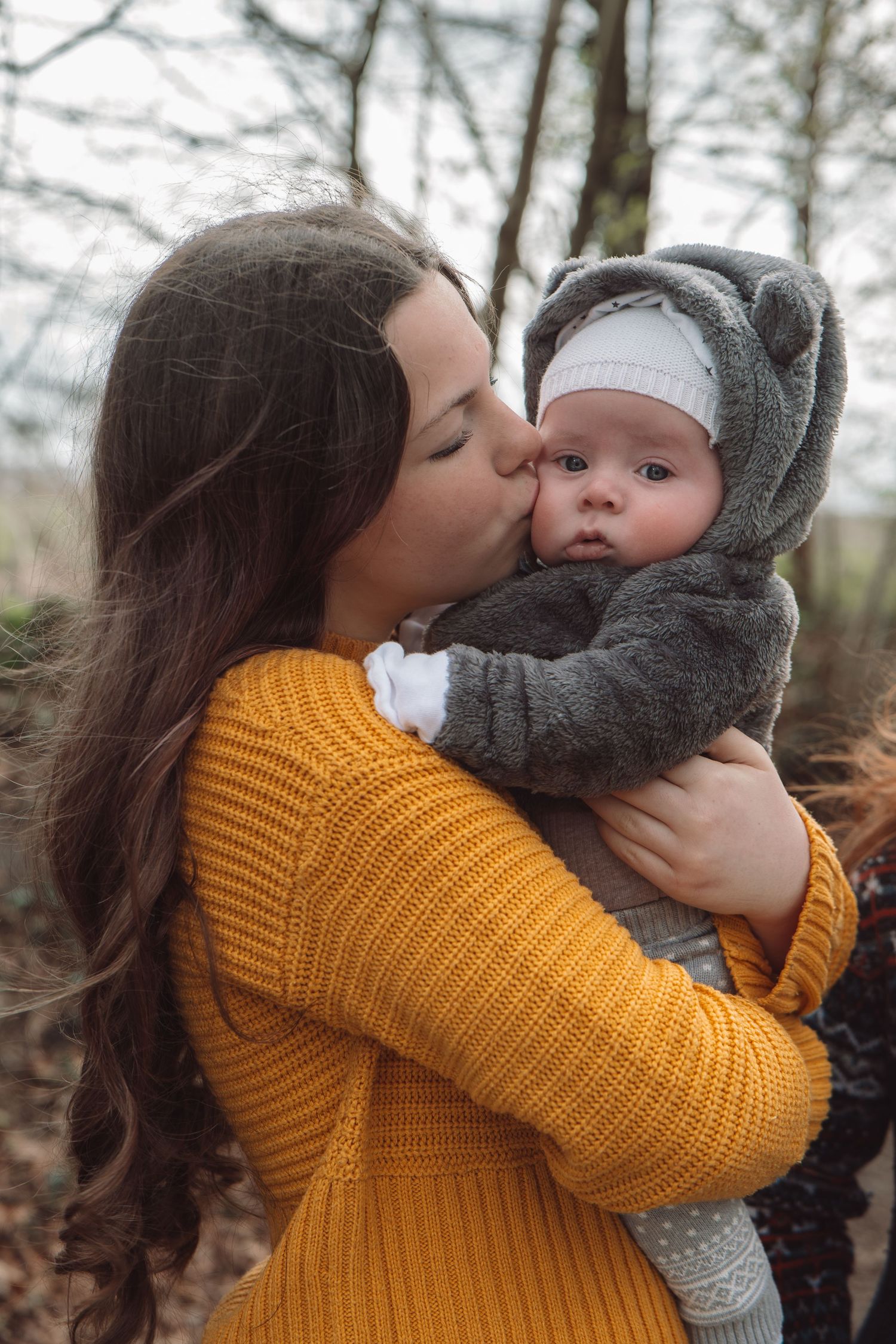 Big sister cuddling baby brother during relaxed lifestyle photography session in Dorset, UK