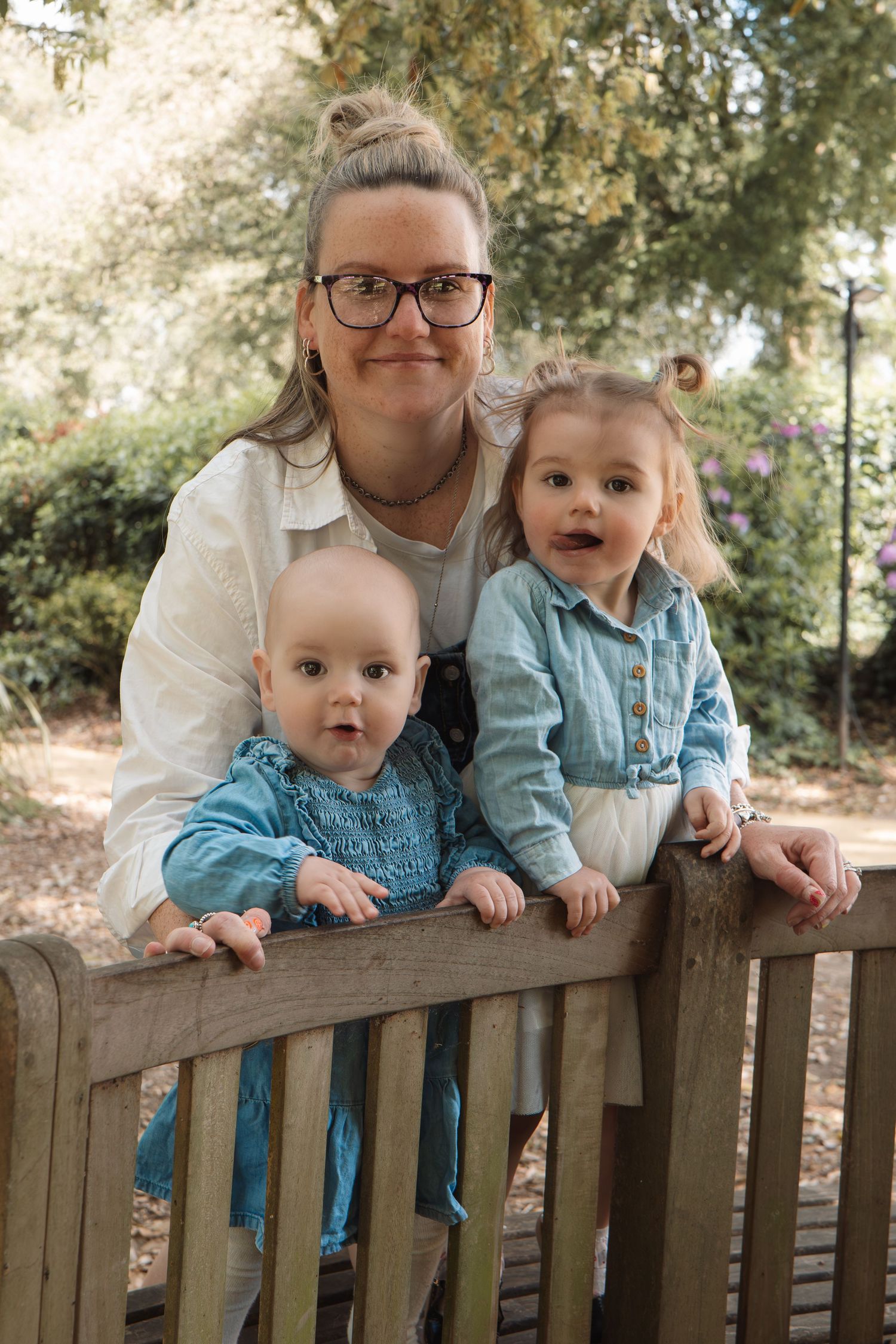 Candid family moment of a mother and her two children during outdoor photoshoot