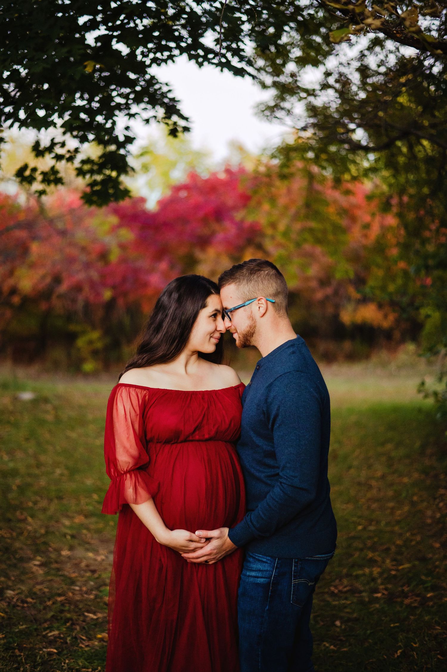 Mom and Dad touching foreheads while holding baby belly. Ottawa Maternity Photography. Ottawa Family Photographer.