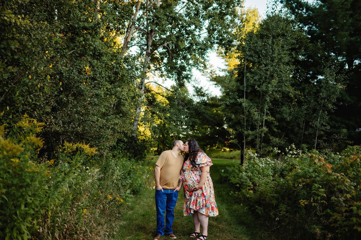 Husband and wife kissing holding baby belly. Ottawa Maternity Photography. Ottawa Family Photographer.