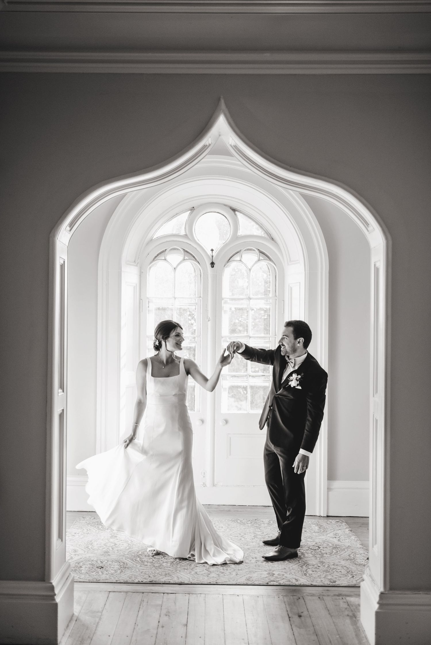 Bride and Groom dancing in iconic window inside Strathmere Inn. Ottawa Wedding Photographer and Videographer
