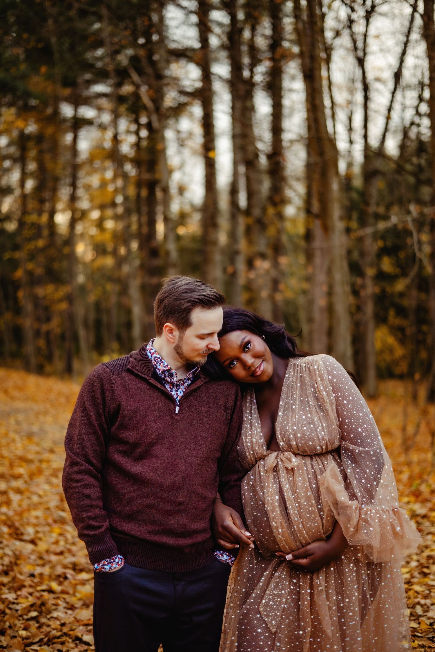 Husband kissing wife while she holds baby belly. Ottawa Maternity Photography. Ottawa Family Photographer.