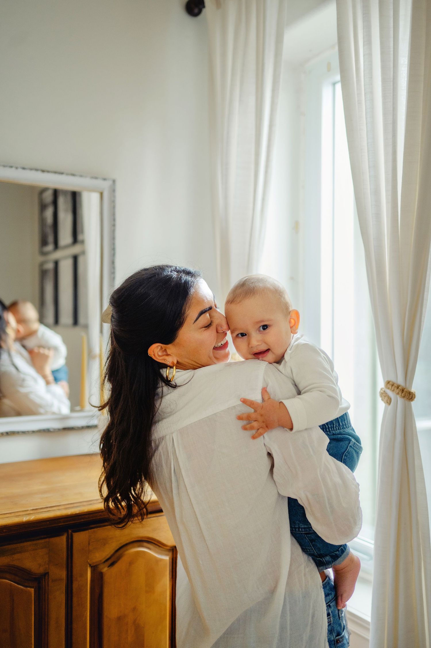 Mom holding son while son looks over her shoulder. Ottawa Family Photographer. Ottawa Newborn Photographer.