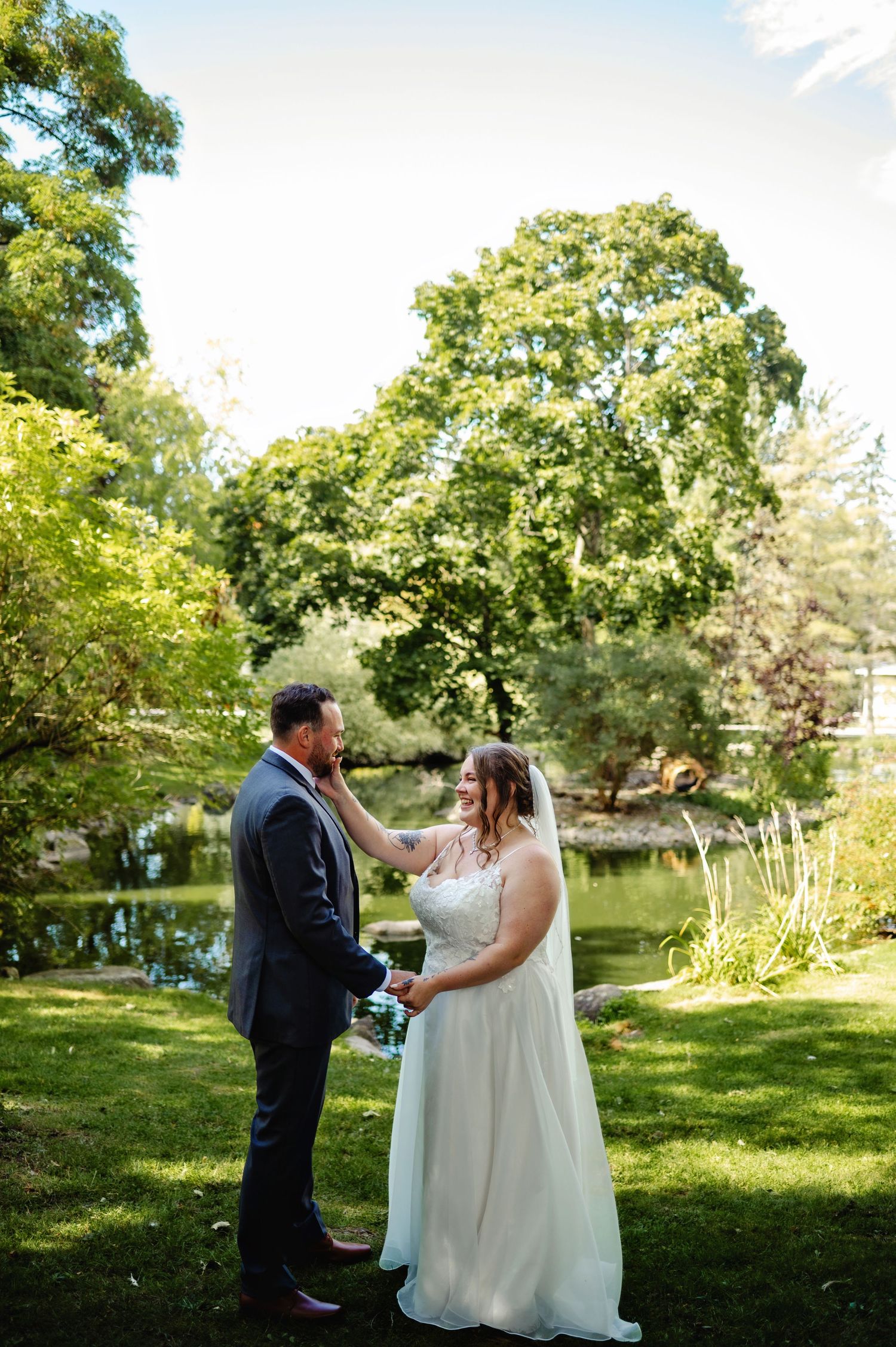 Bride wiping grooms tears during first look. Ottawa Wedding Photographer and Videographer