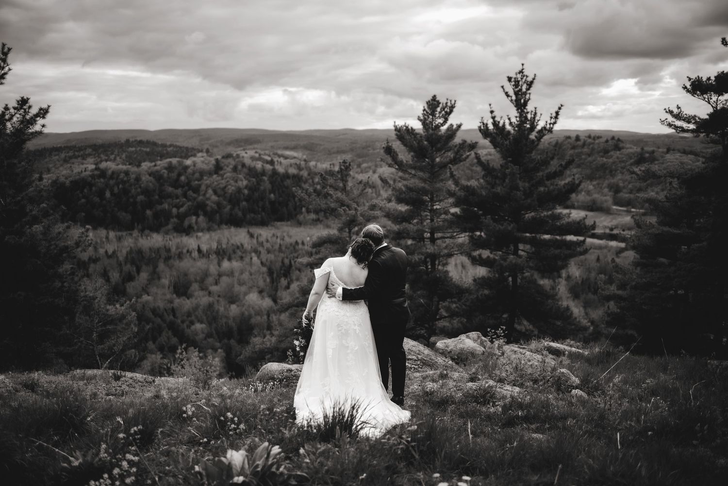 Bride leaning her head on grooms shoulder on cliffs edge at Le Belvedere. Ottawa Wedding Photography. Ottawa Wedding Videography.