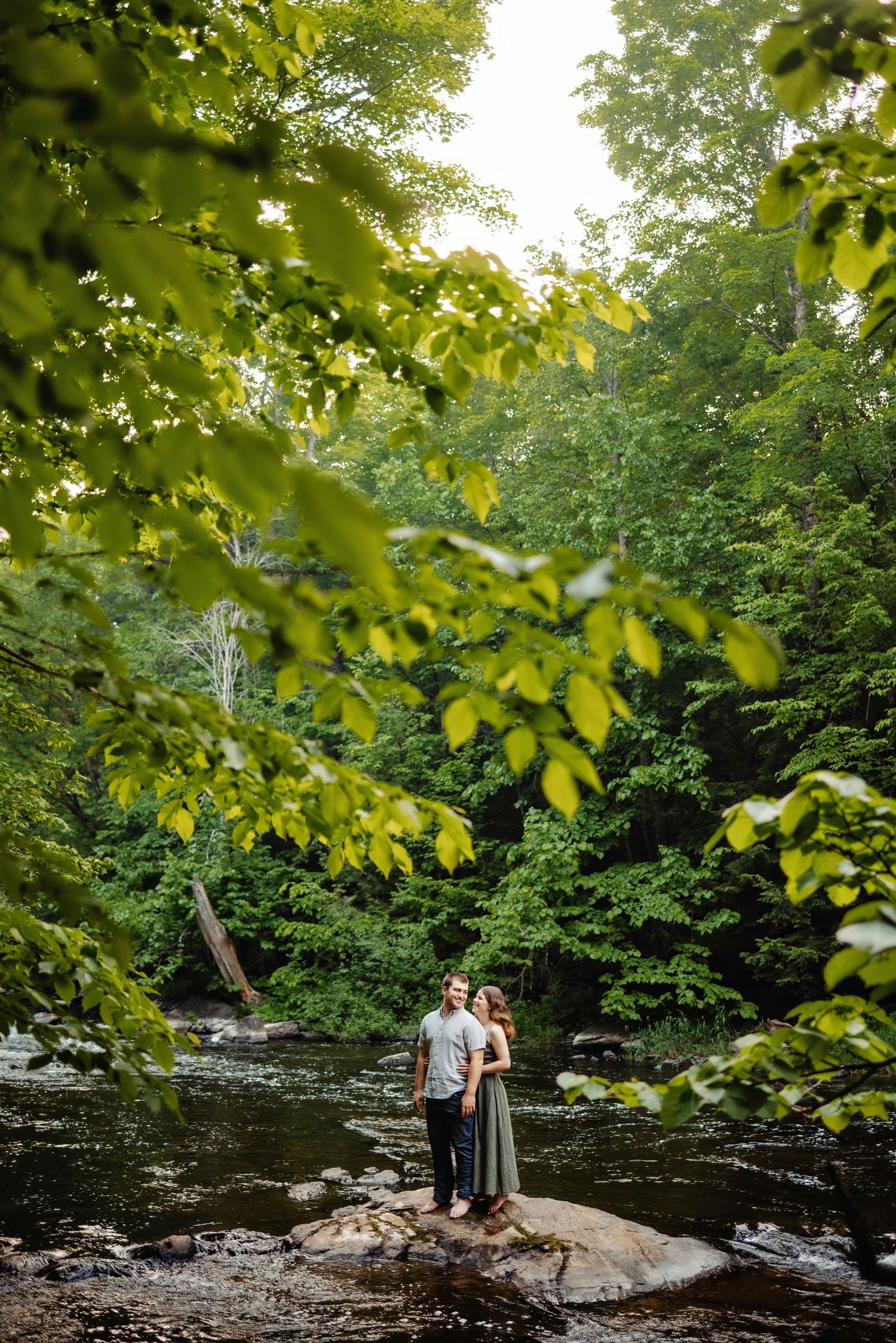 Couple standing on rock in river. Ottawa Wedding Photographer. Ottawa Couples Photographer