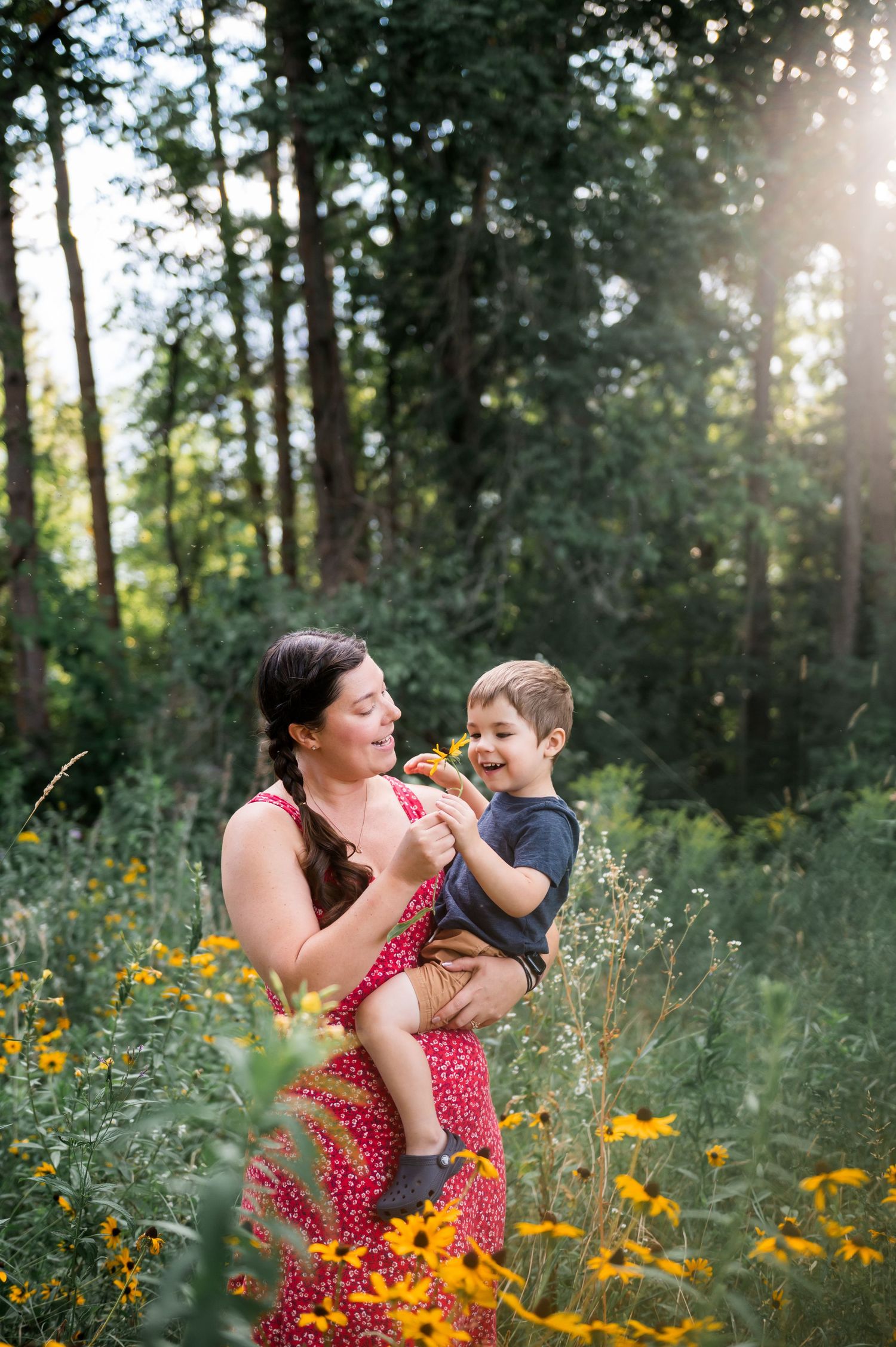 Shauna smelling a flower with her son. Ottawa Wedding Photographer and Videographer