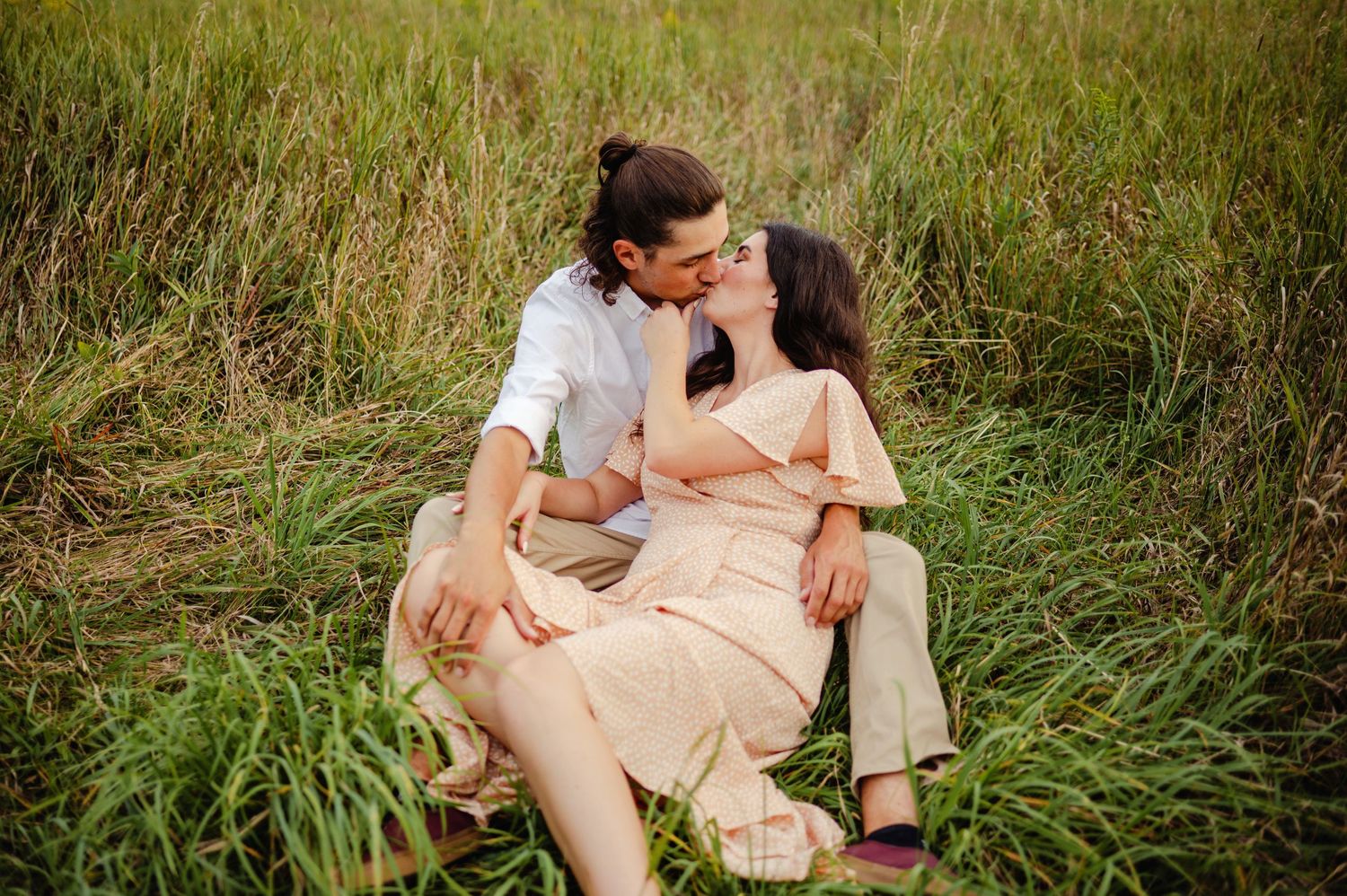 Couple kissing in tall grass. Ottawa Wedding Photographer. Ottawa Couples Photographer