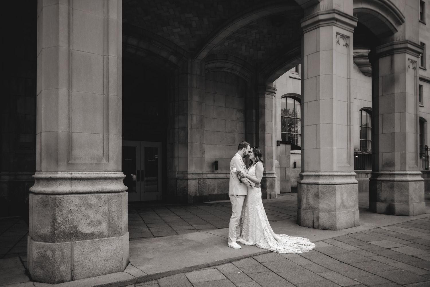 Bride and groom touching foreheads outside Chateau Laurier downtown Ottawa. Ottawa Wedding Photography. Ottawa Wedding Videography.