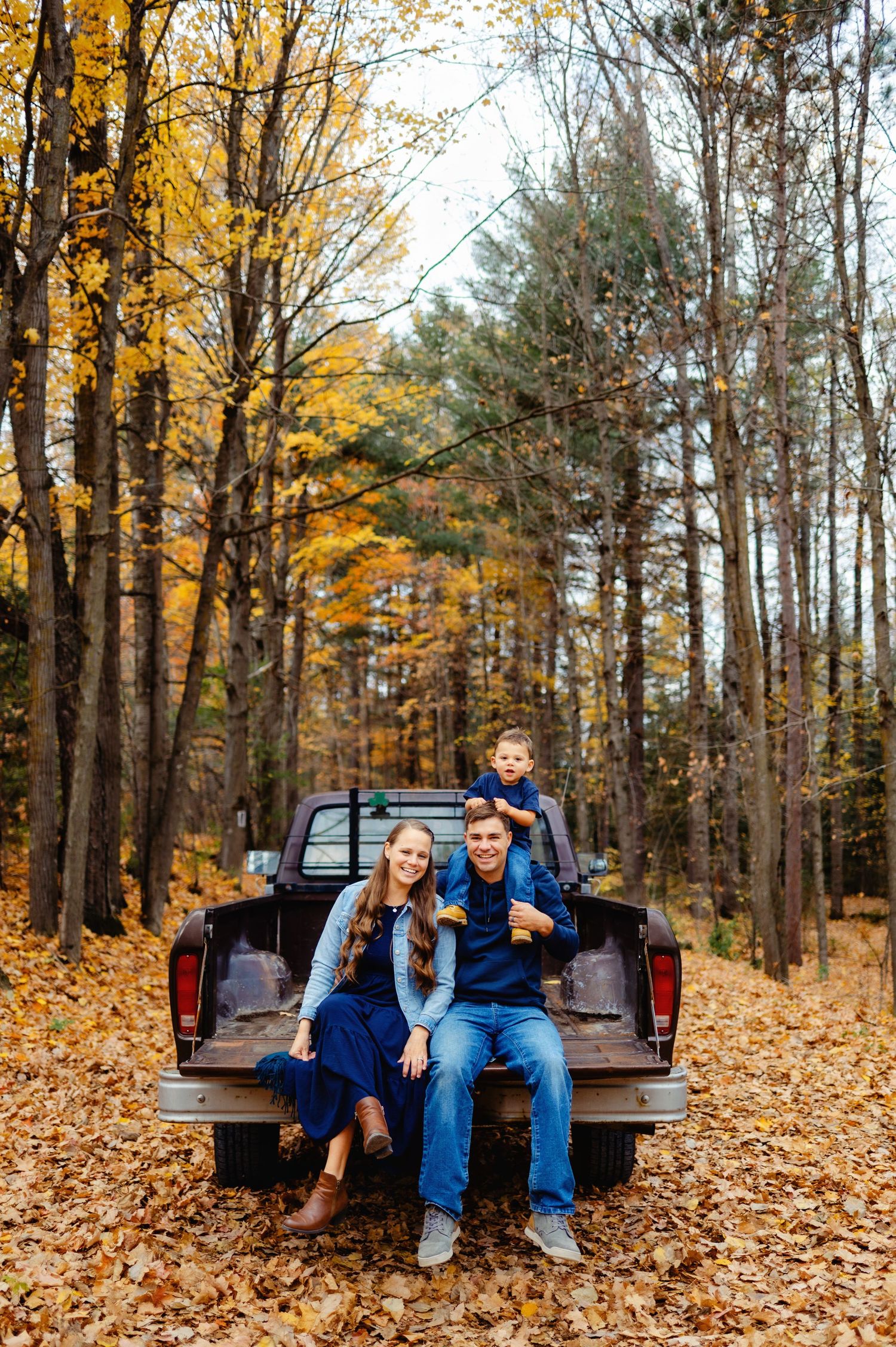 Family sitting on back of old truck tailgate. Ottawa Family Photographer. Ottawa Fall Mini's Photographer