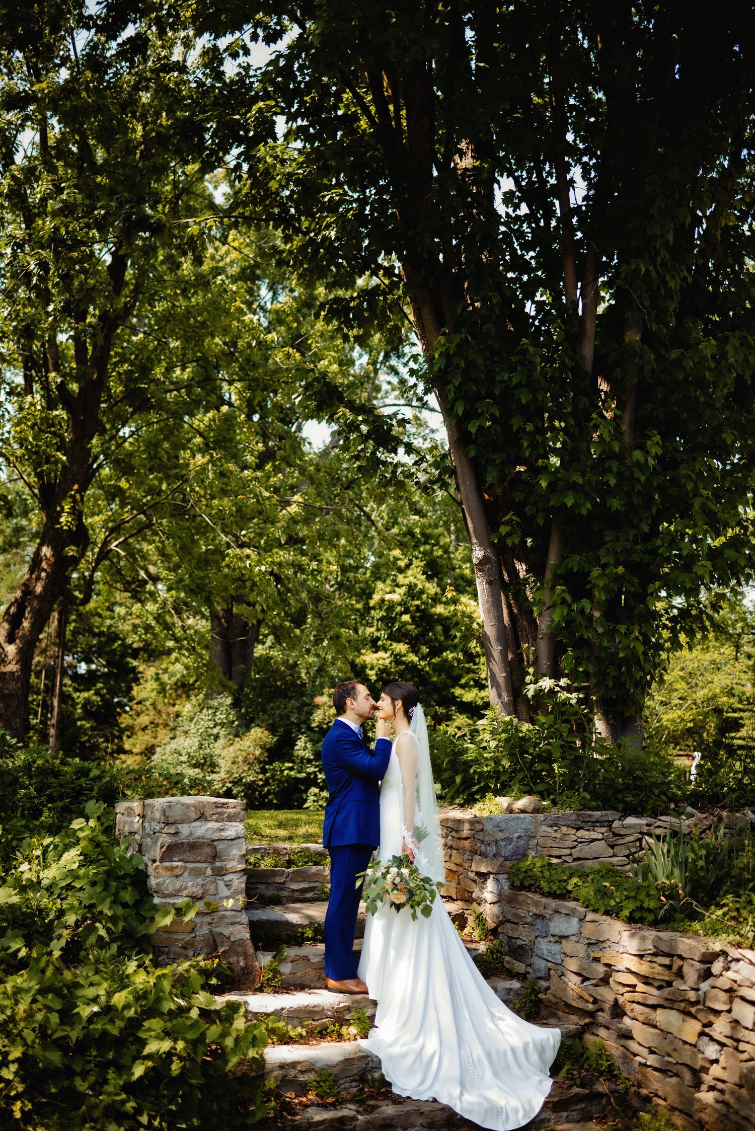 Groom teasing bride with kissing on steps. Ottawa Wedding Photography. Ottawa Wedding Videography.