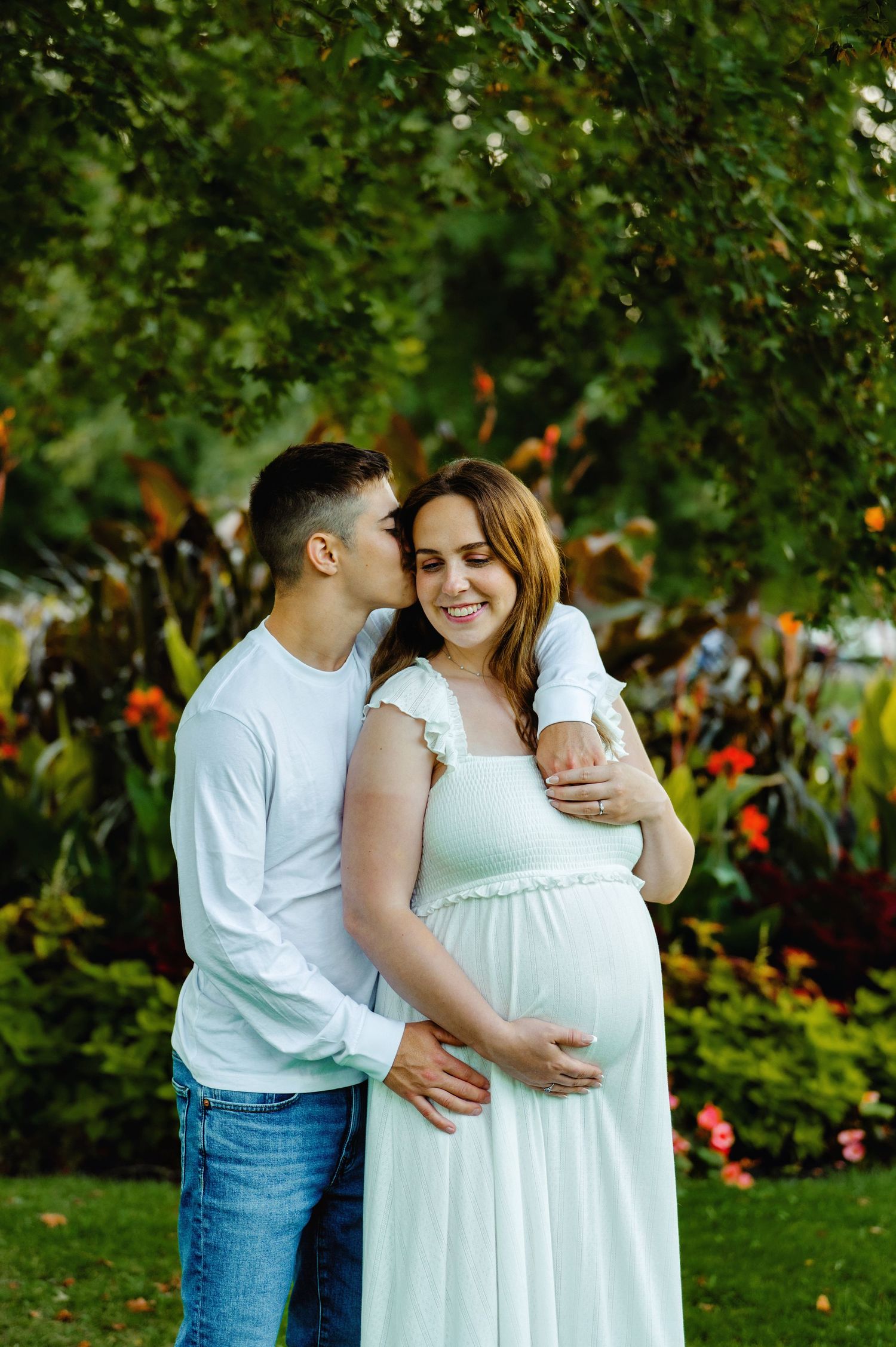 Mom and dad cuddled holding baby belly. Ottawa Maternity Photography. Ottawa Family Photographer.