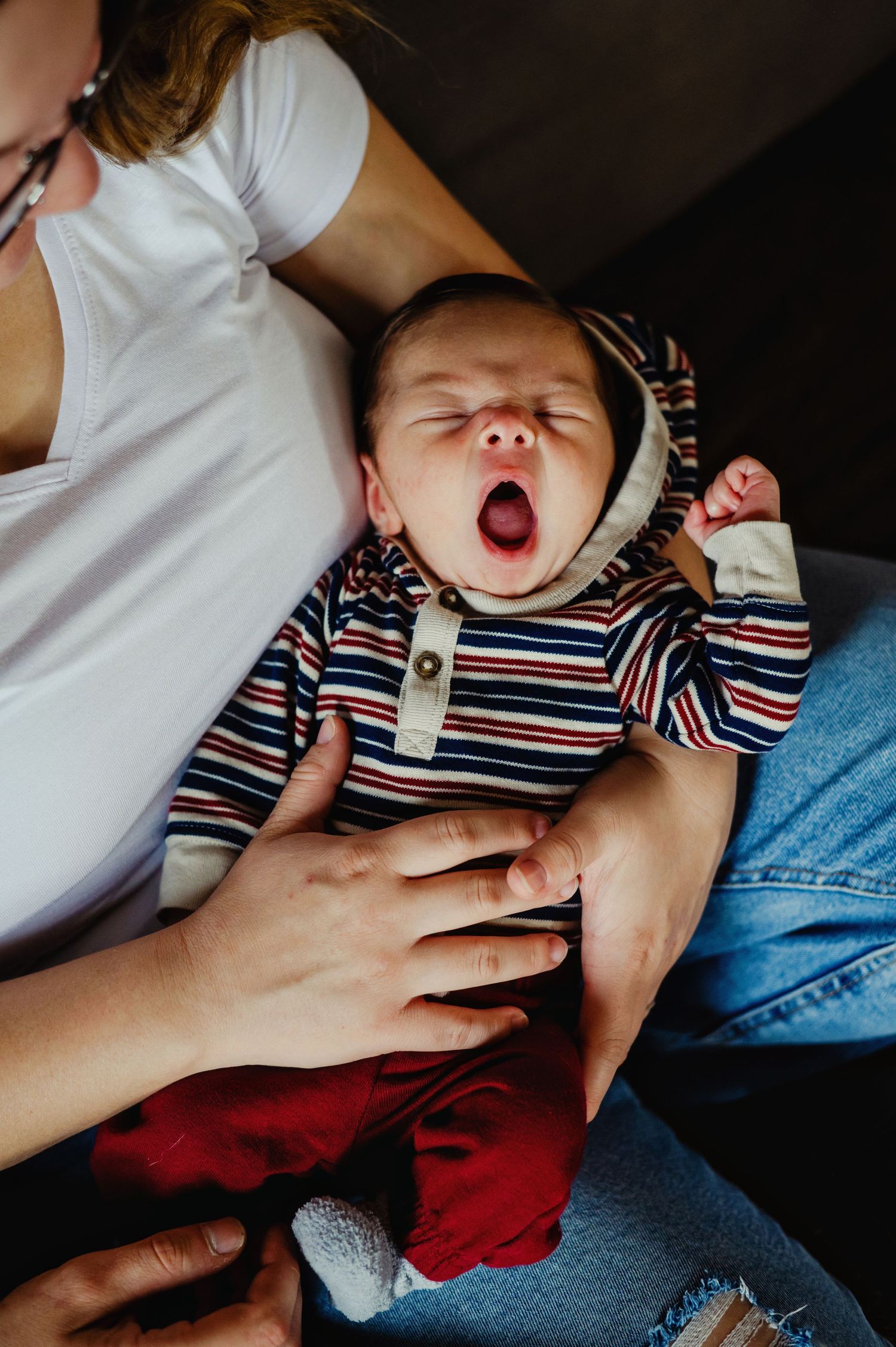 Newborn yawning in moms arms. Ottawa Newborn Photography. Ottawa Family Photography