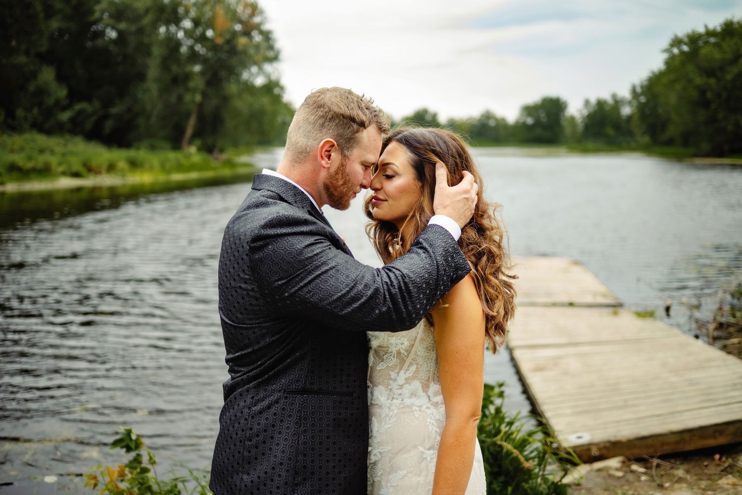 Groom pulling brides hair back out of her face while touching foreheads. Ottawa Wedding Photography. Ottawa Wedding Videography.