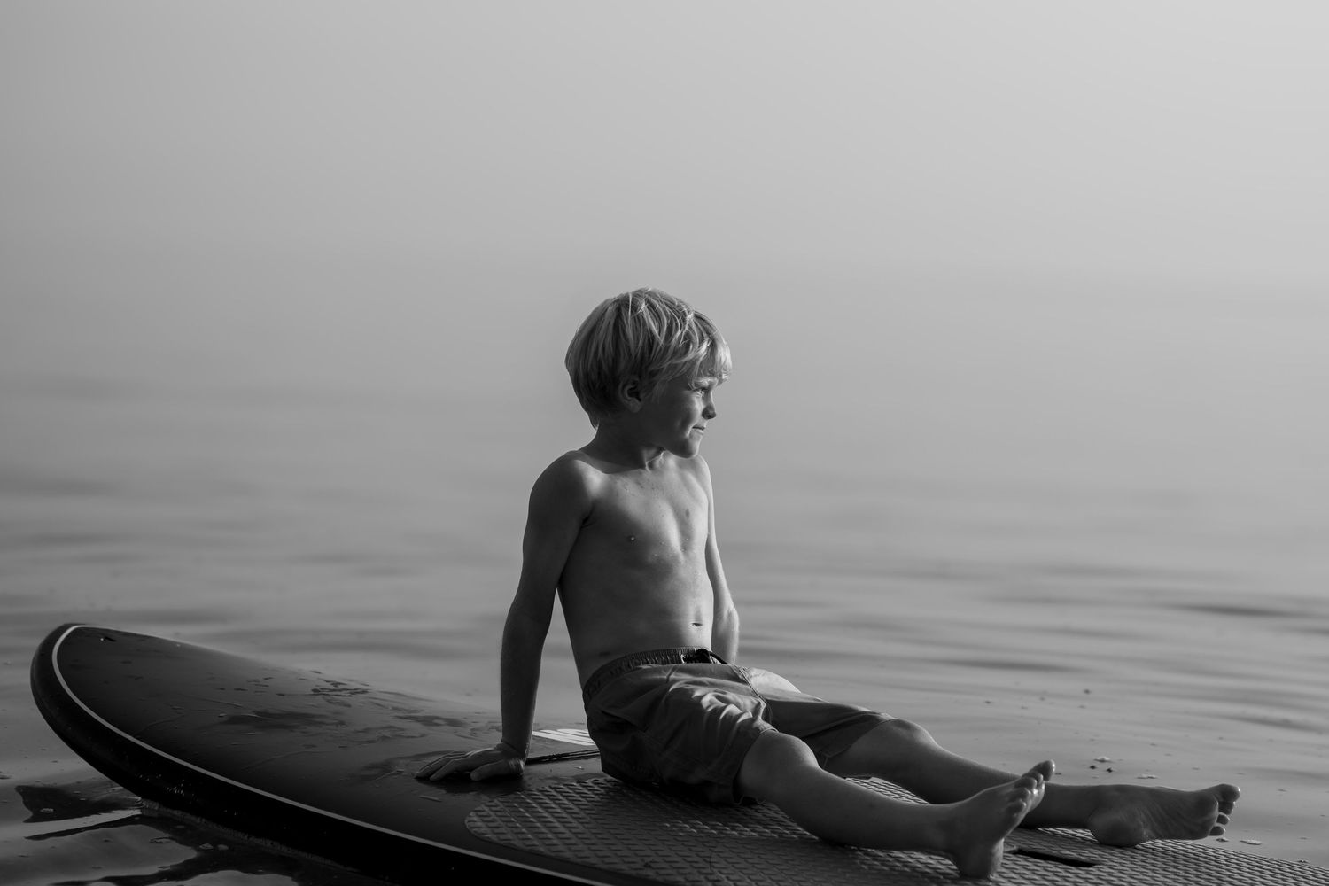 Boy on paddle board, in the evening sun, South Devon