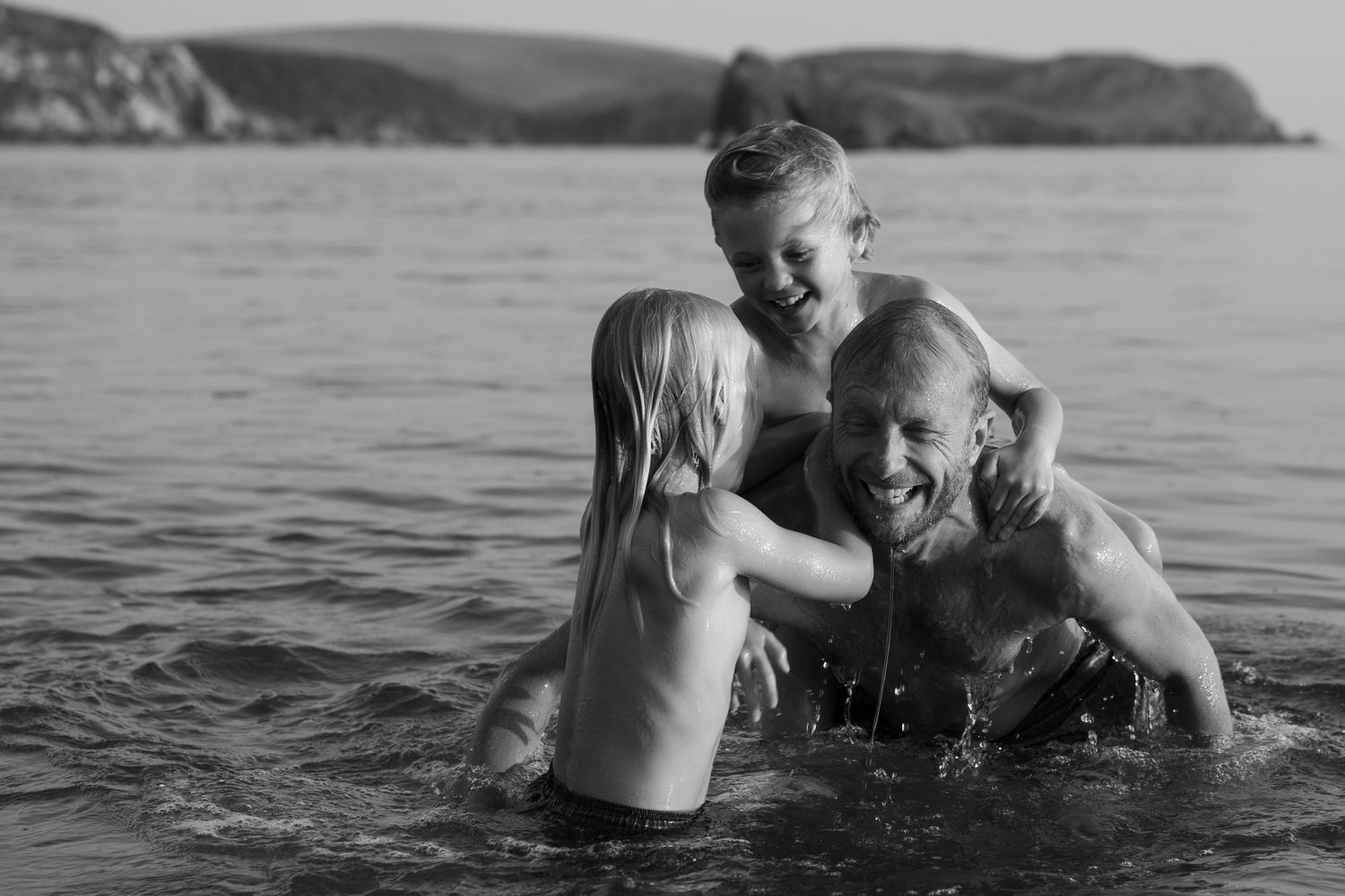 Father and son playing in the water, South Devon