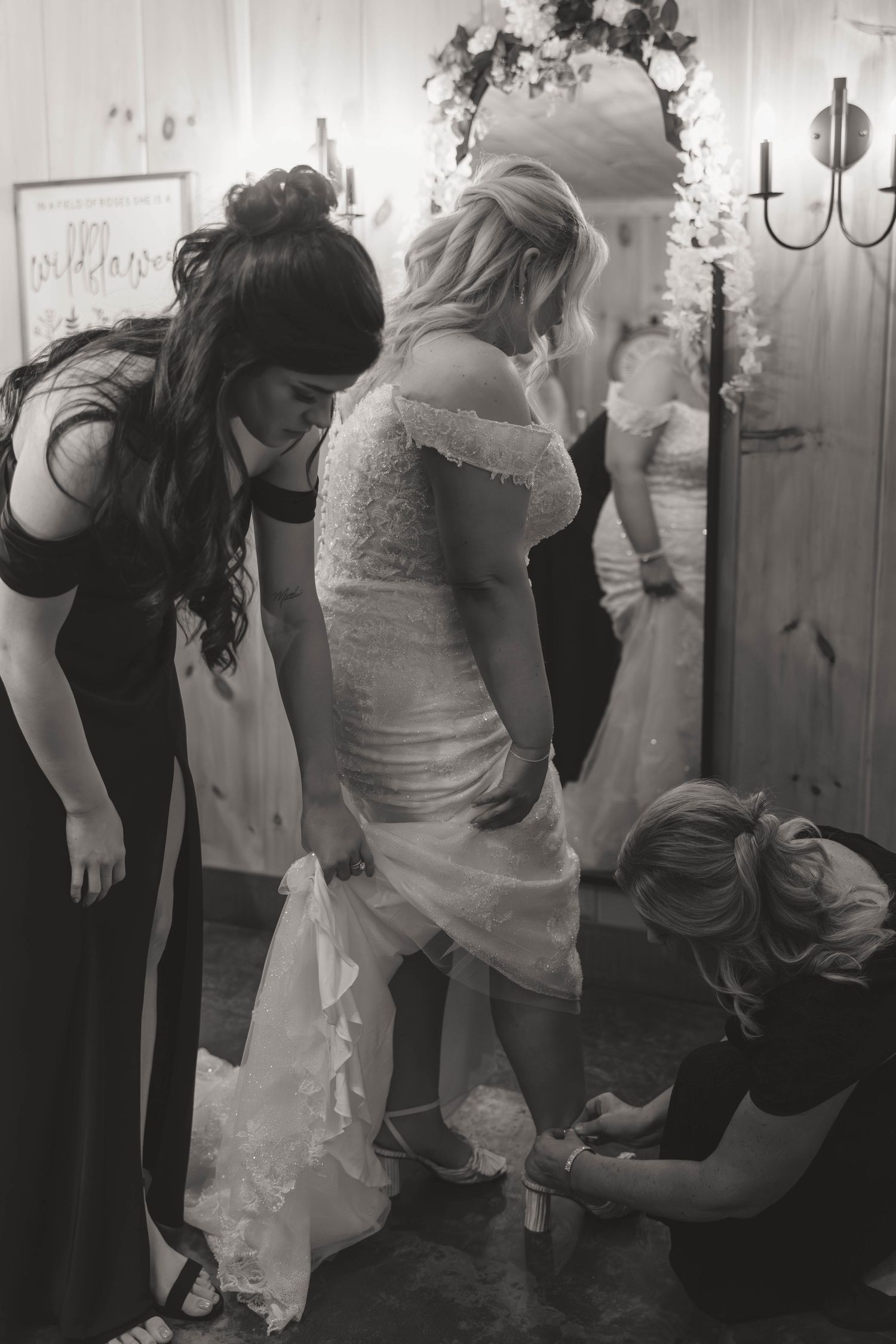 Black and white image of wedding preparations in dressing room.