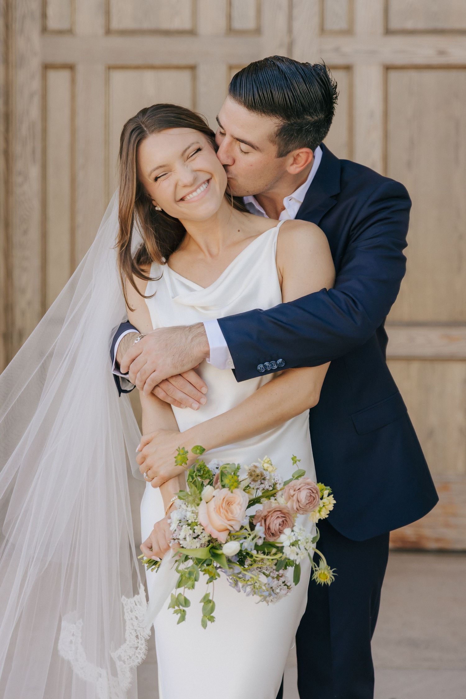 A series of romantic wedding photos showing an elegant couple embracing in a light-filled indoor venue.