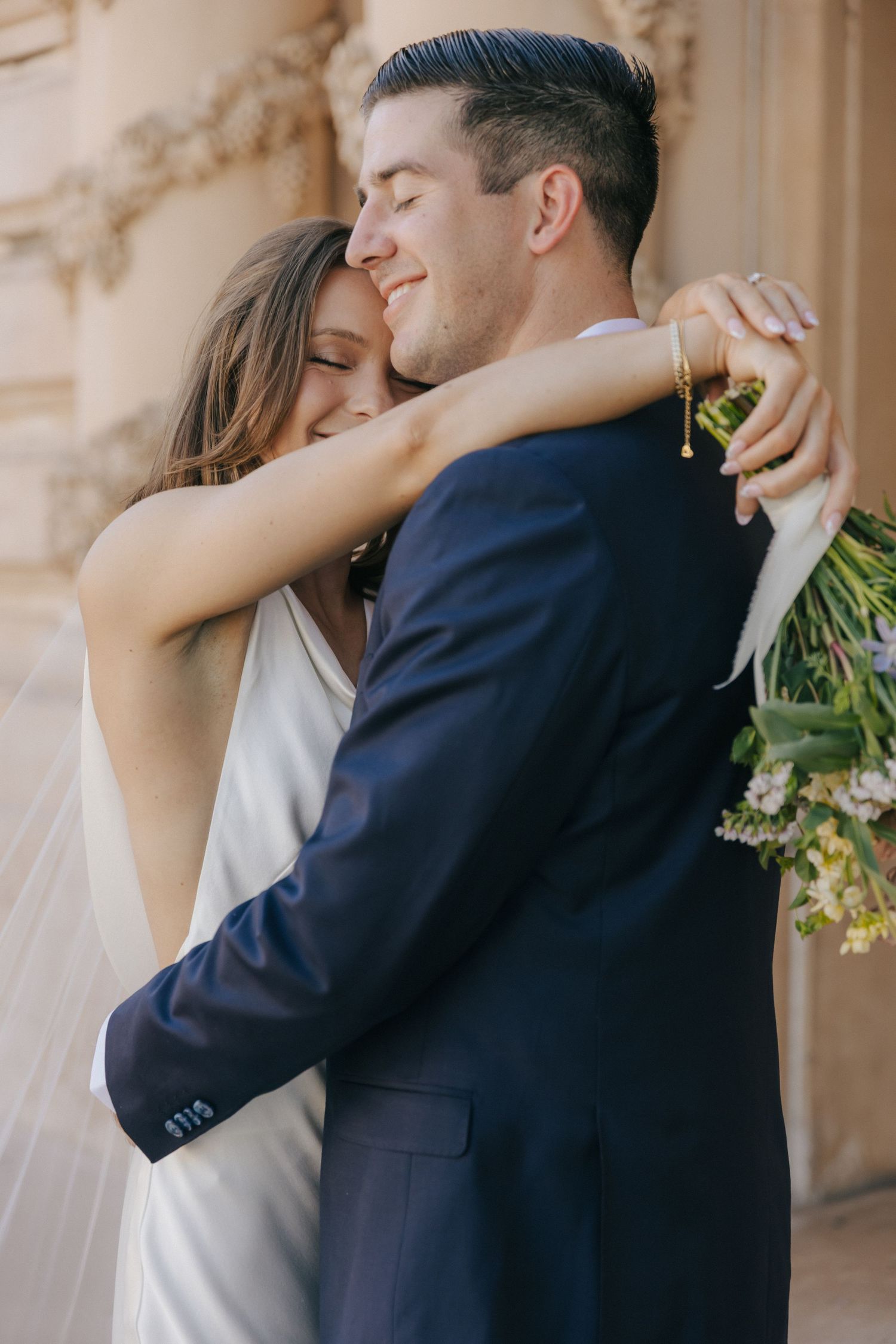 A romantic wedding couple embraces and shares tender moments in a series of intimate photos against a stone backdrop.