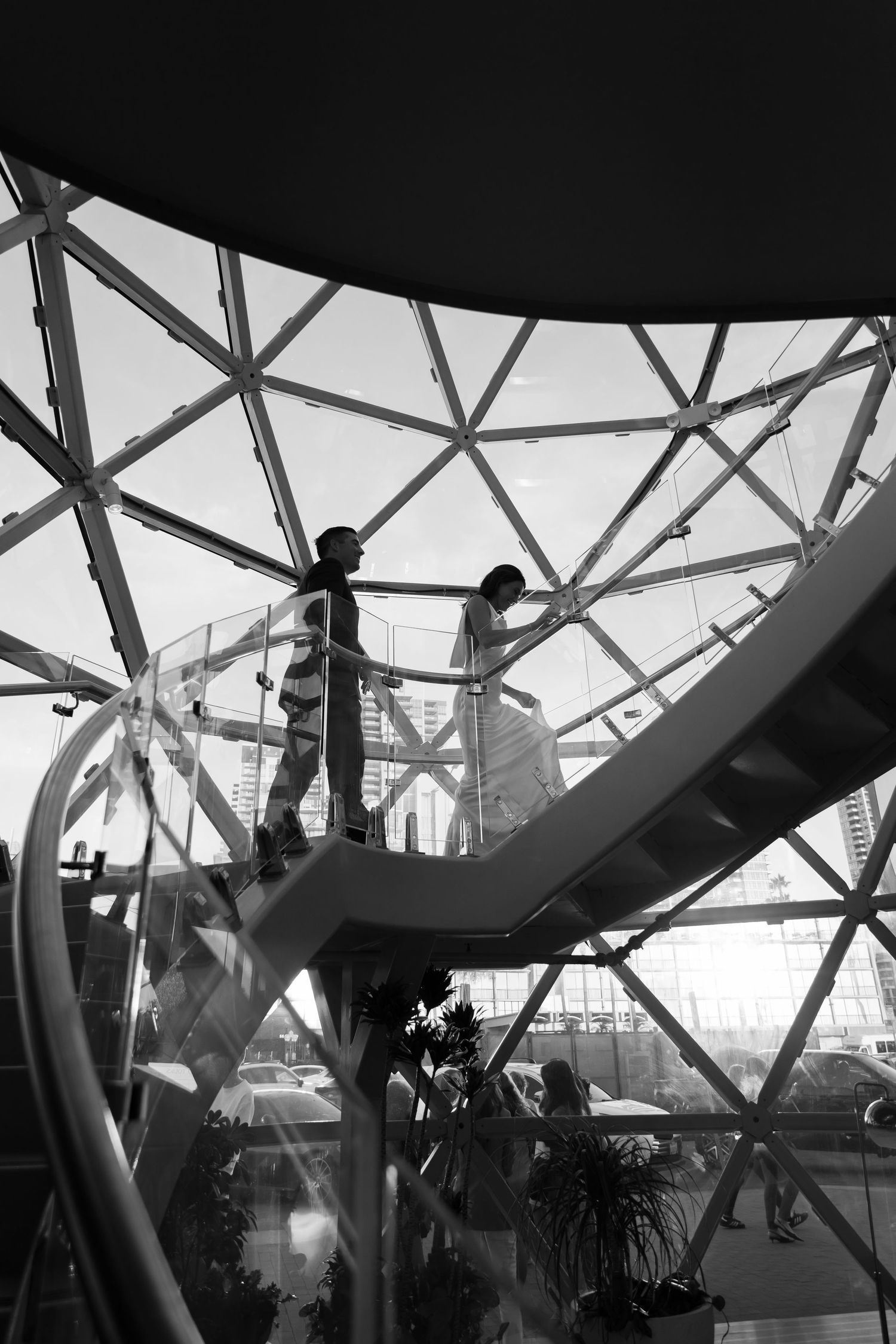 Black and white architectural images showing geometric patterns of glass and steel beams in a modern structure.