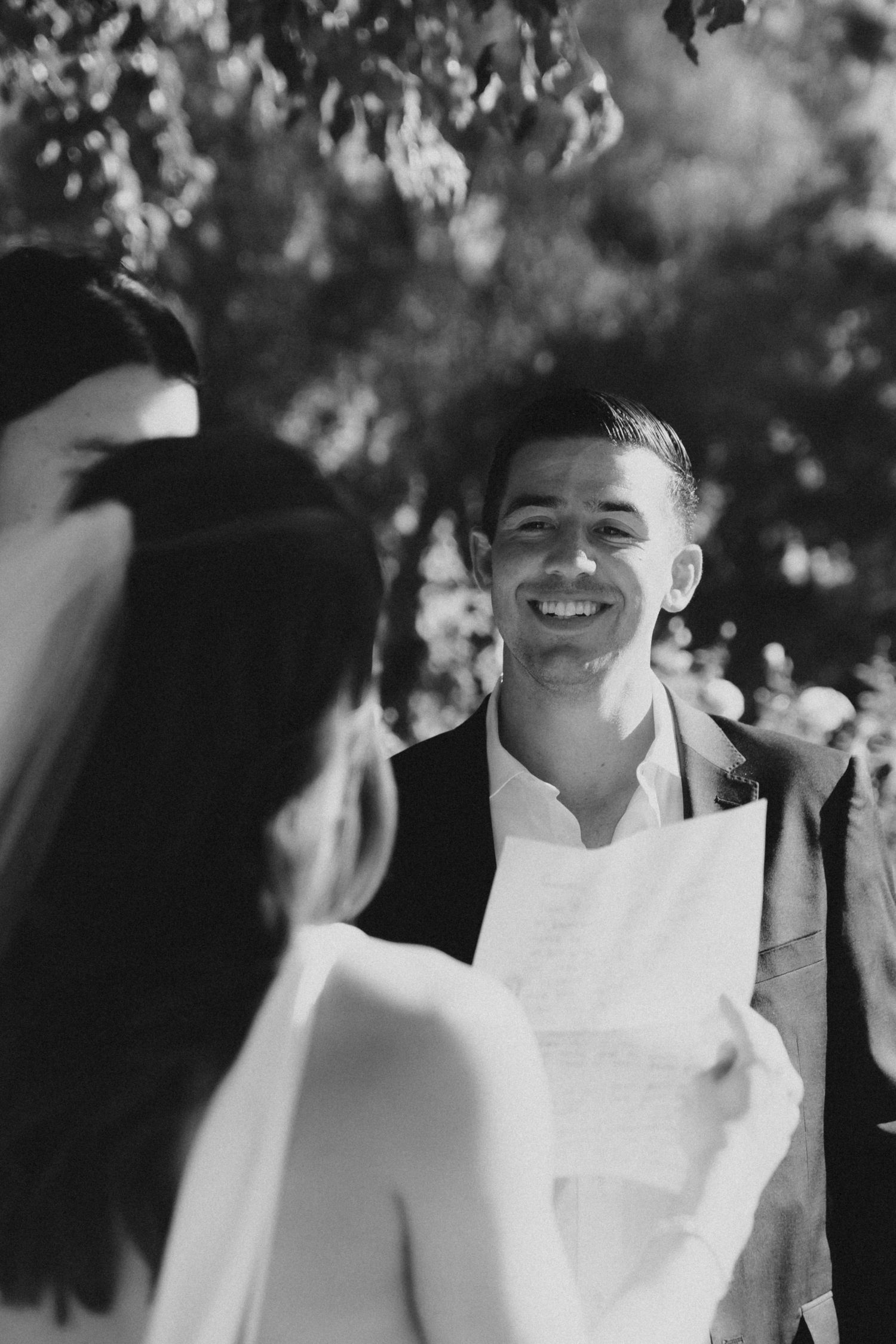Black and white photo series showing joyful expressions and candid moments at an outdoor celebration.