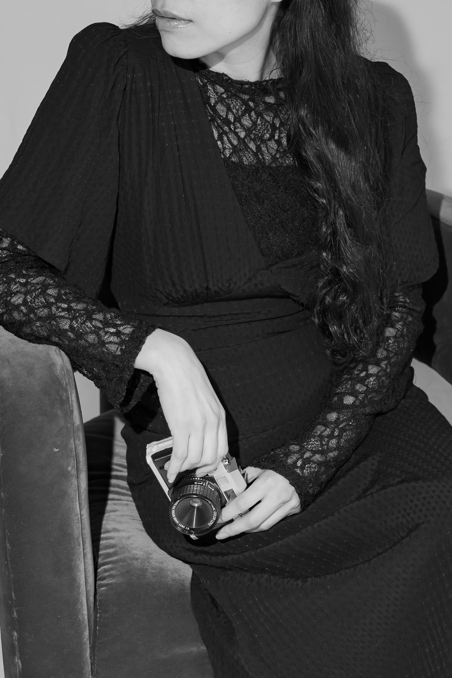 A women sitting on a studio couch posing