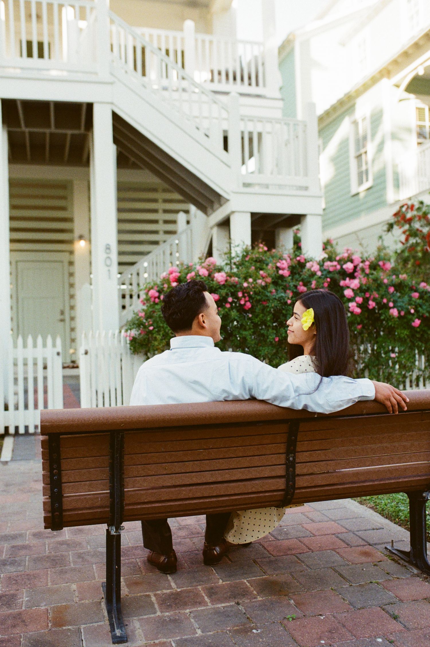 a couple sitting on a bench captured on  film