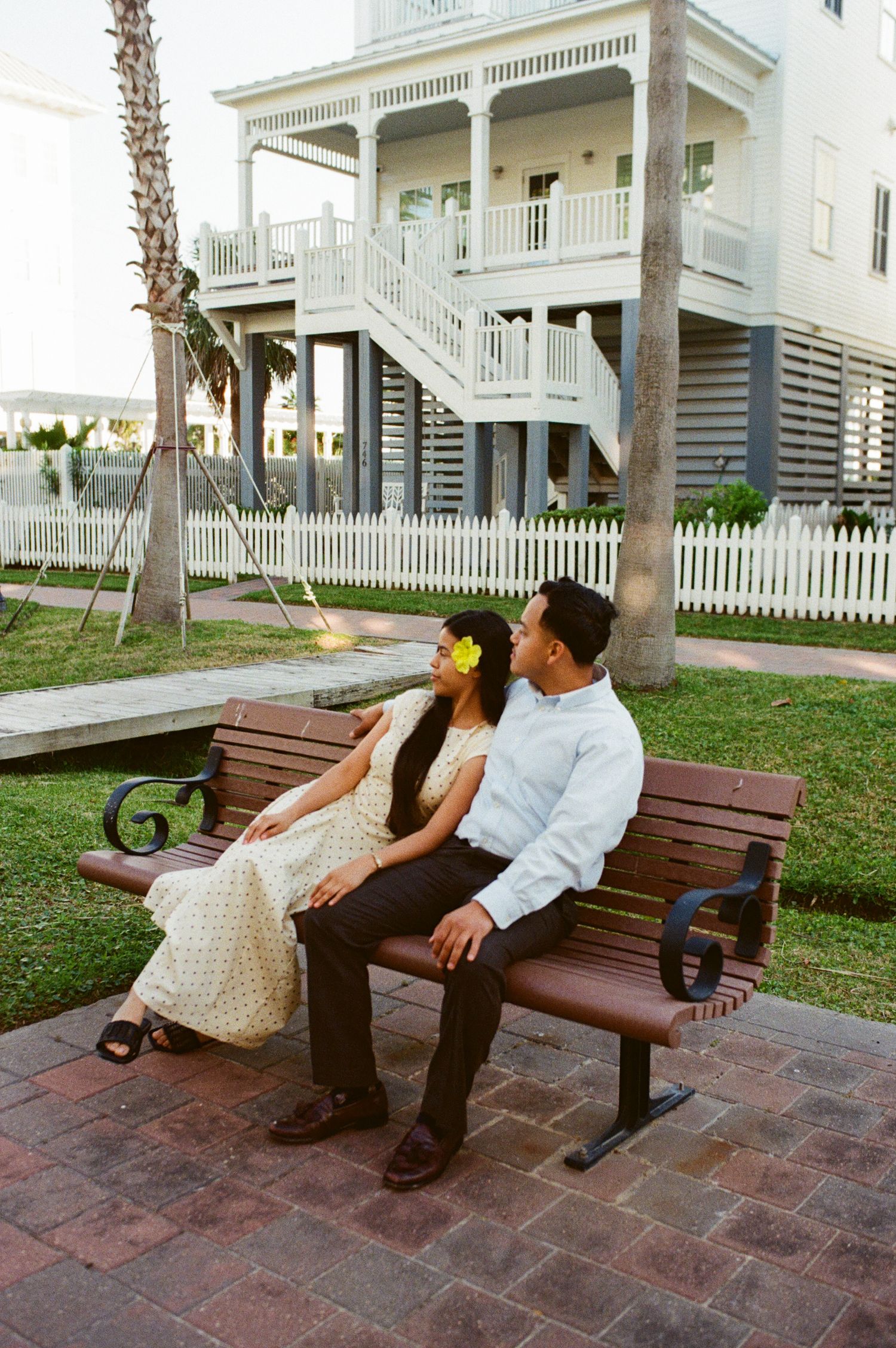 a couple sitting on a bench captured on  film