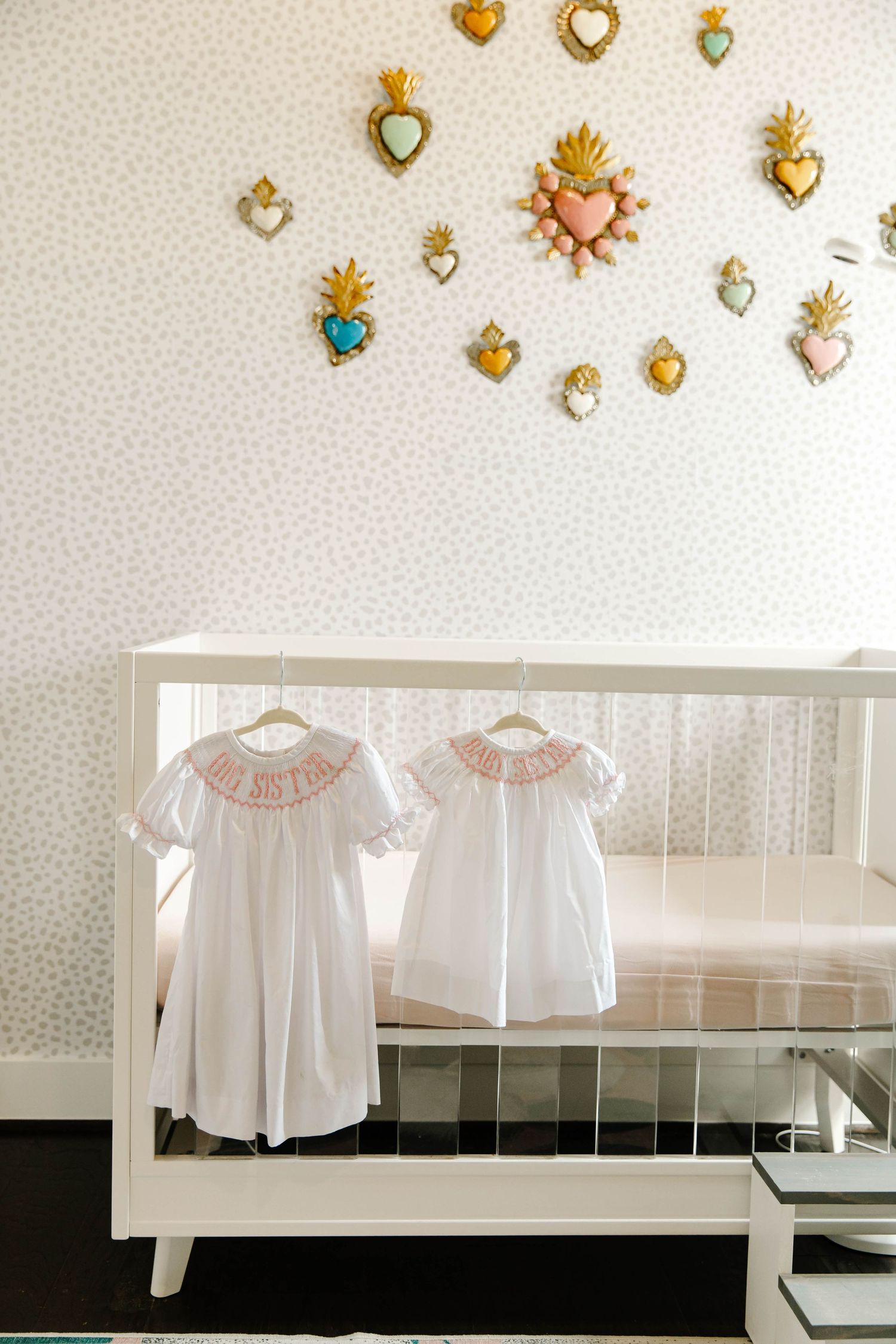 toddler dresses hanging on the crib