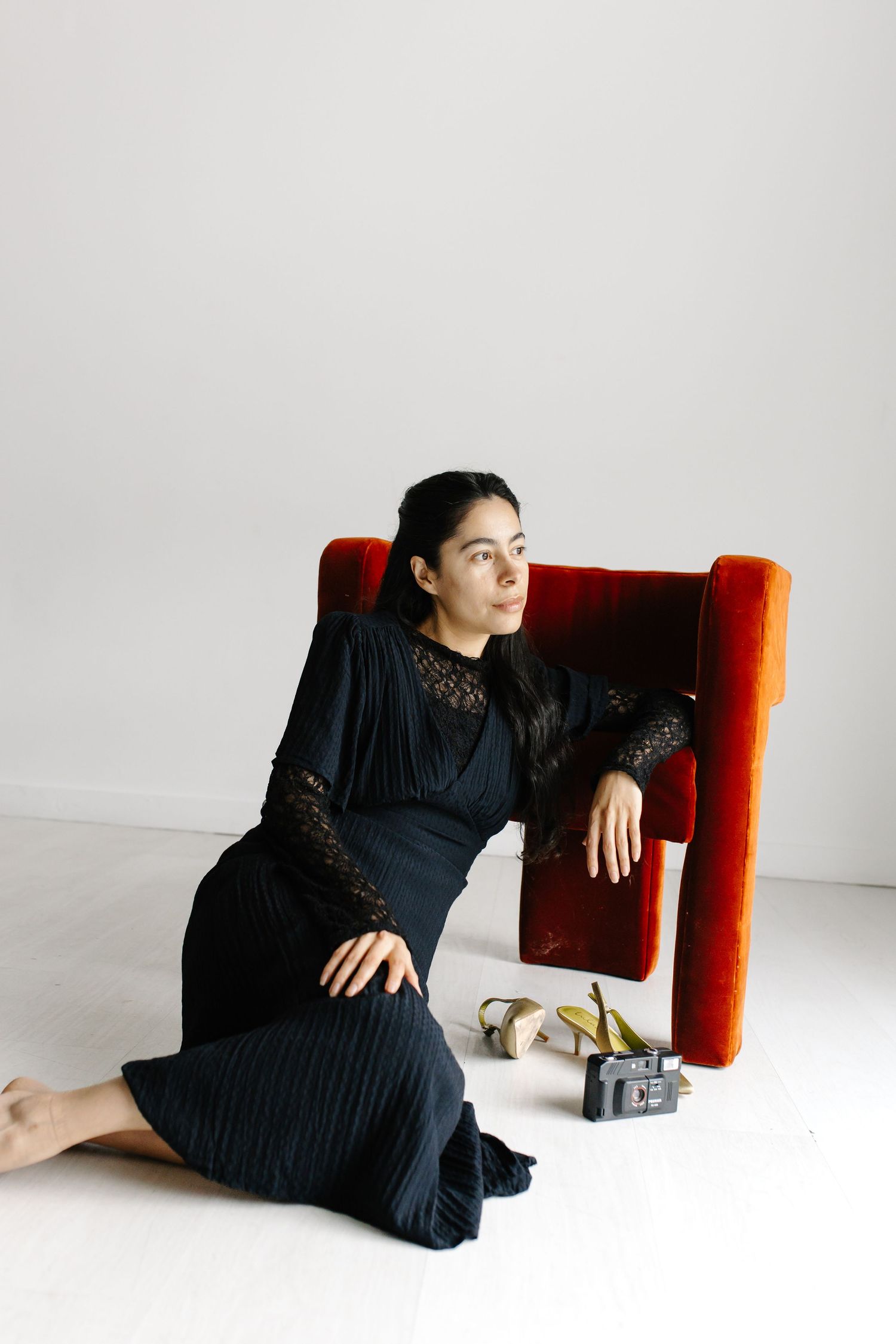 a lady sitting on the ground looking away for a portrait