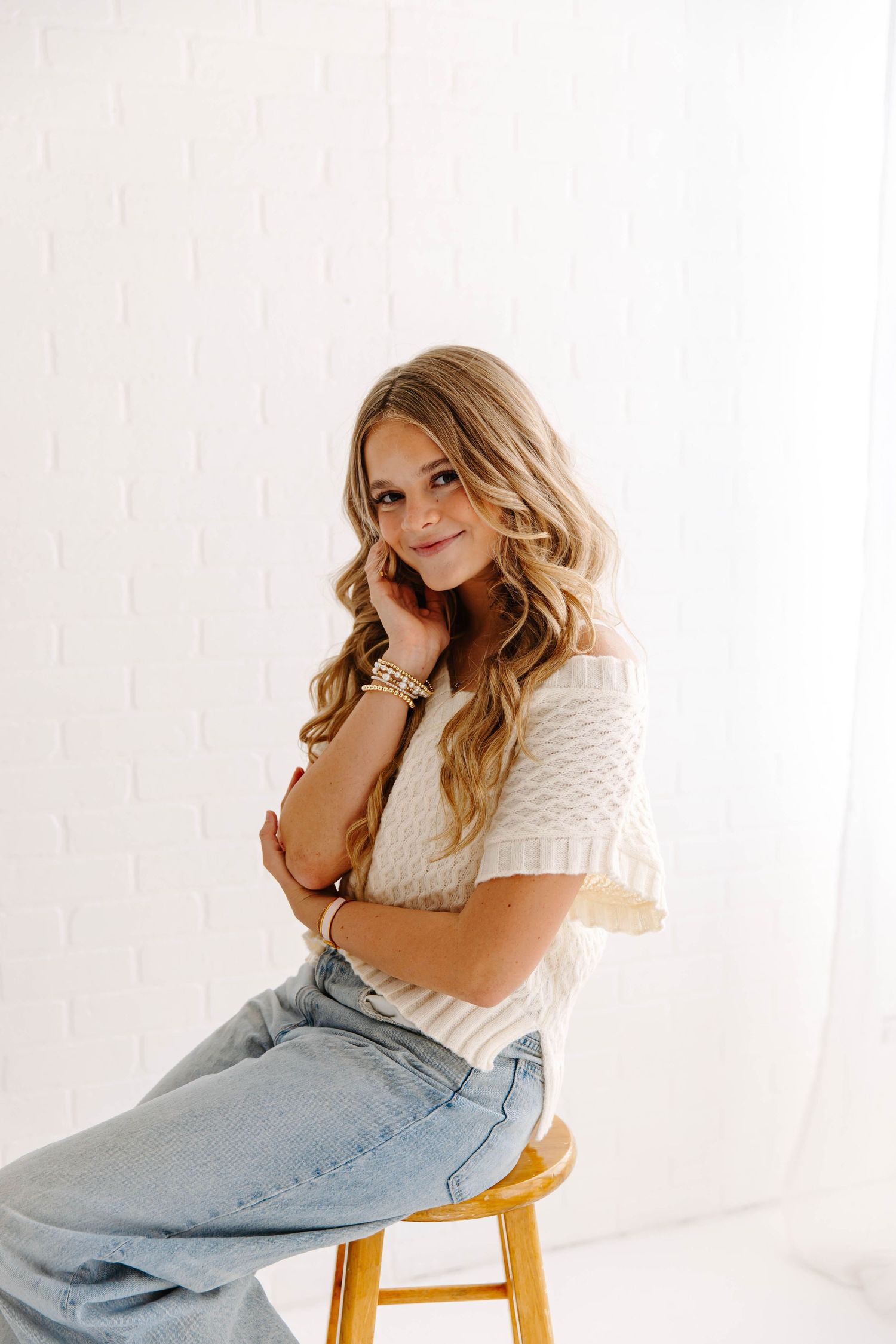senior portraits in studio sitting on chair