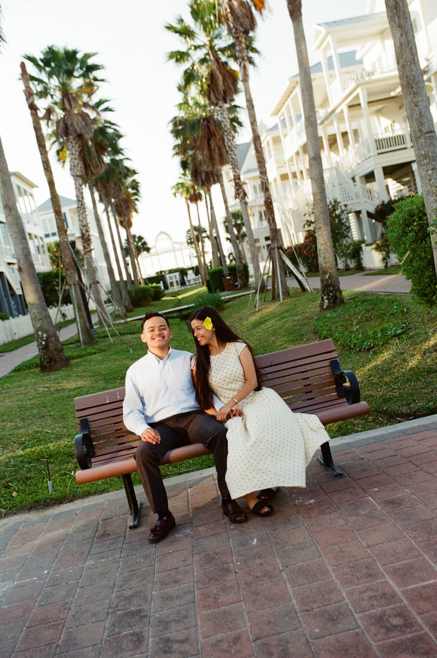 a couple sitting on a bench captured on  film