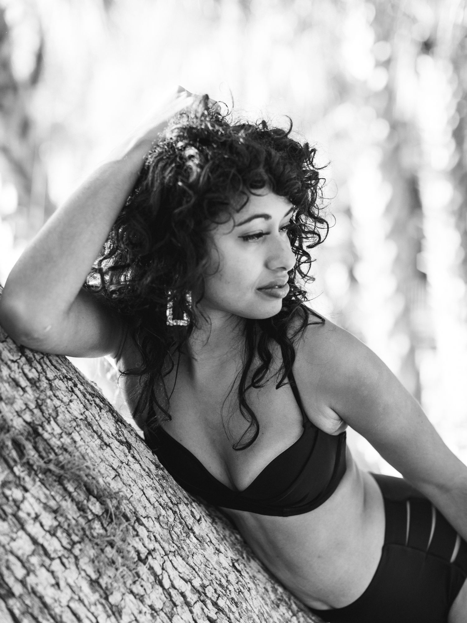 Black and white artistic portrait series showing dynamic poses against a light textured background.
