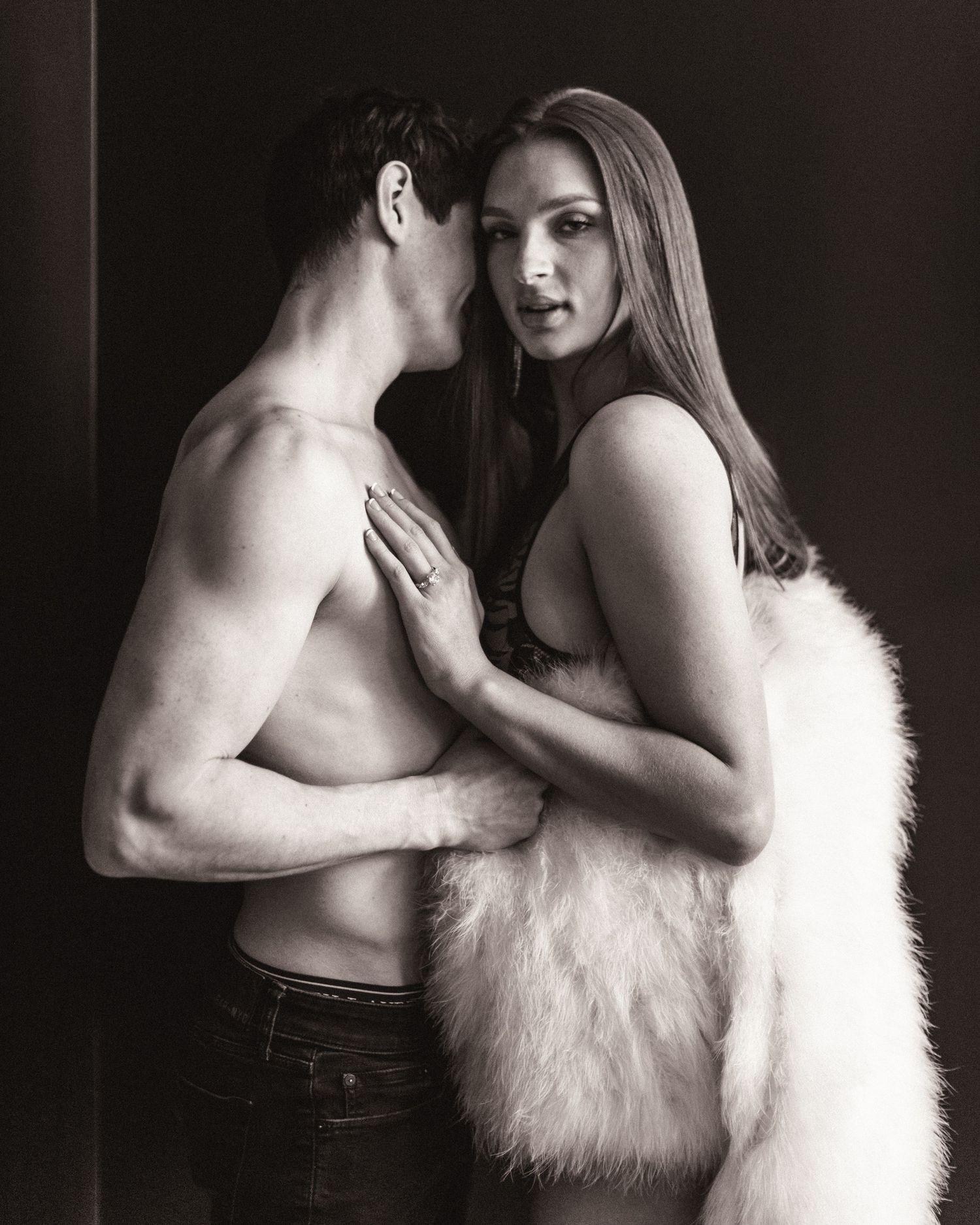 A black and white artistic photo series showing an intimate couple embracing while one wears a white fur wrap.