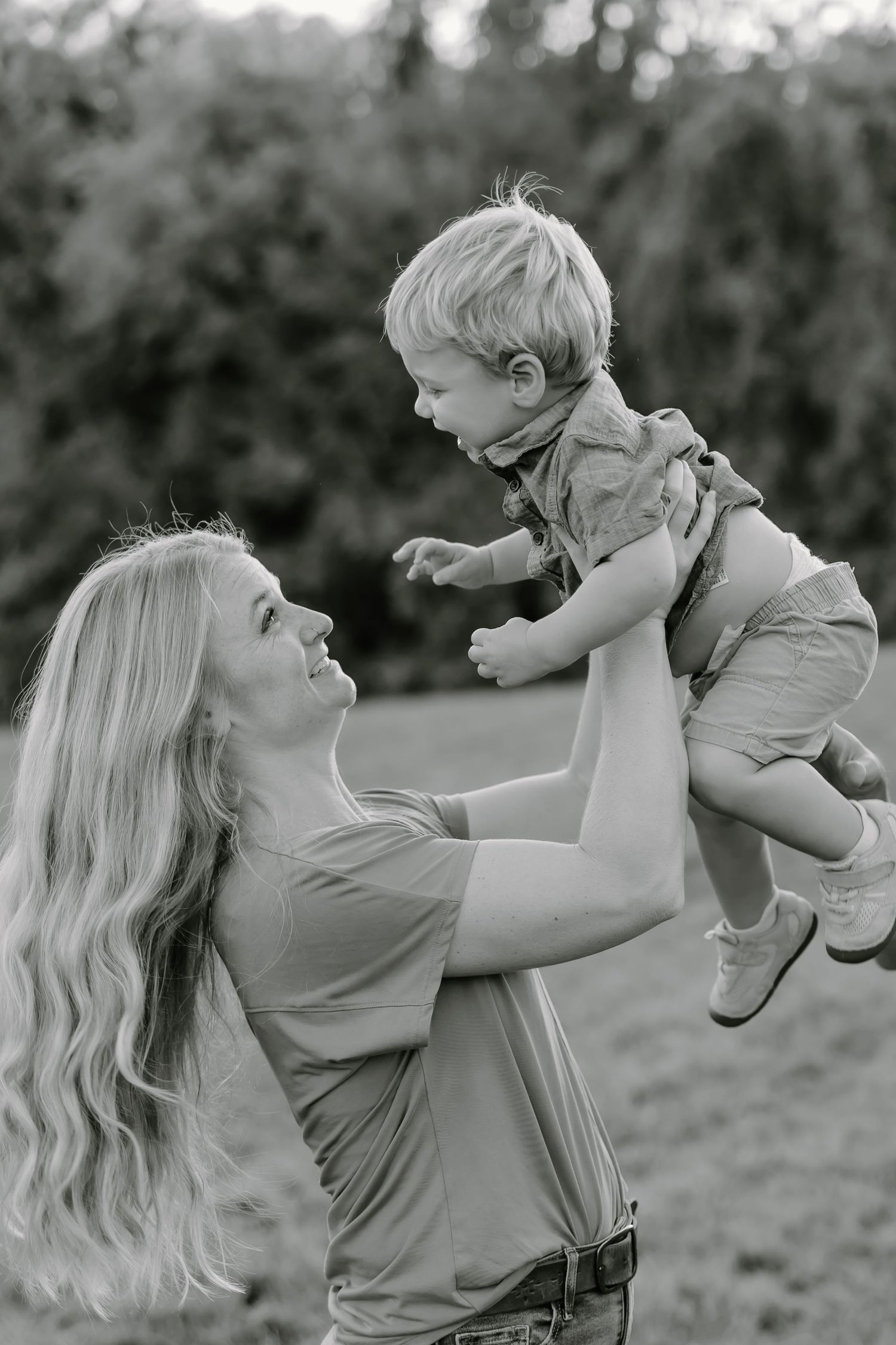 Tender moments of play and connection between parent and child in black and white.