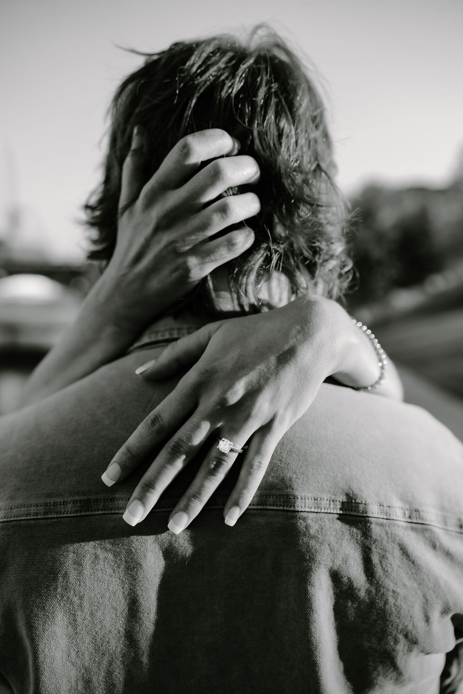 Black and white series showing hands tenderly placed on shoulders.