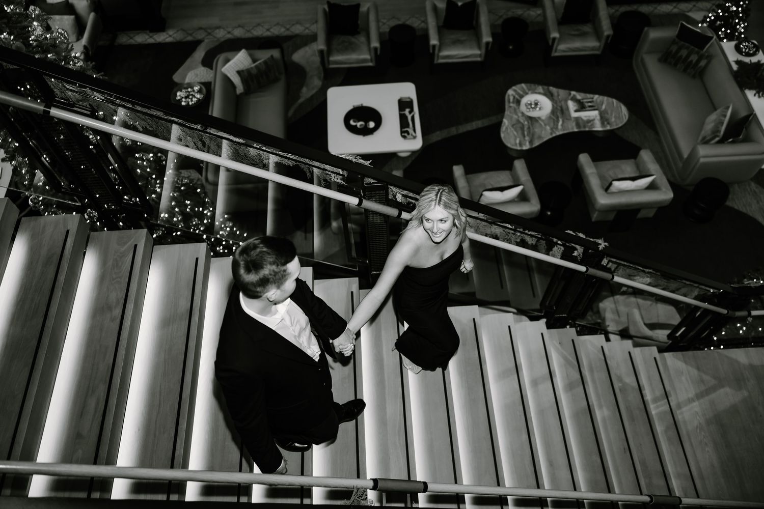 Artistic black and white shot of couple on modern staircase.