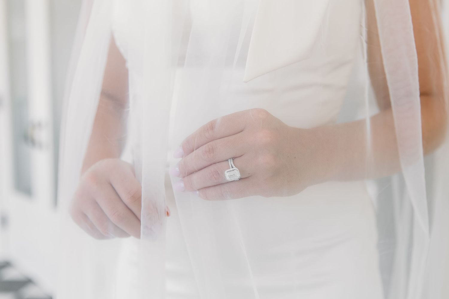 Ethereal white tulle and fabric draping creates an elegant wedding ceremony backdrop.