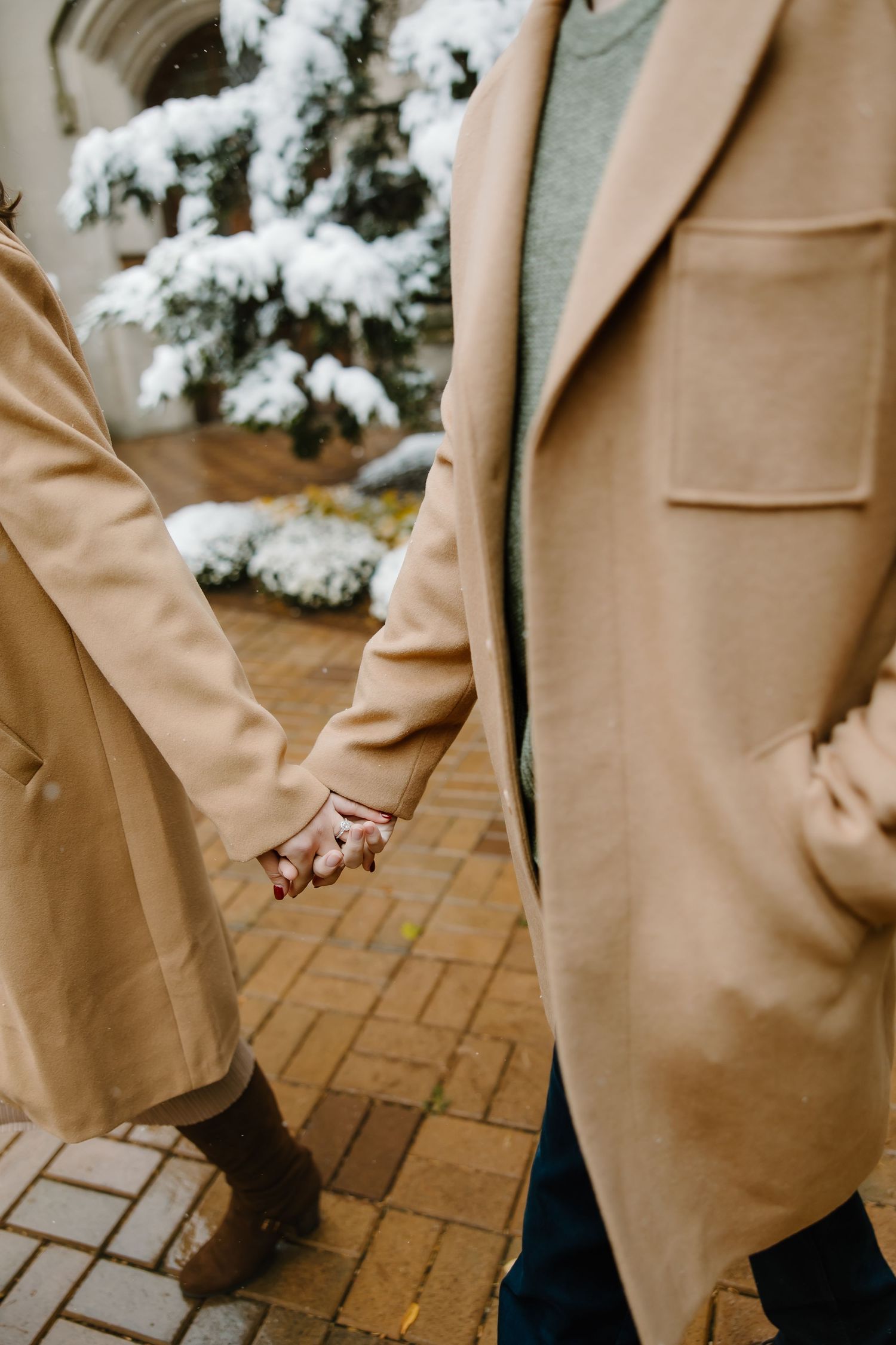 Detail shot of camel colored coats and clothing against snow-covered scenery.