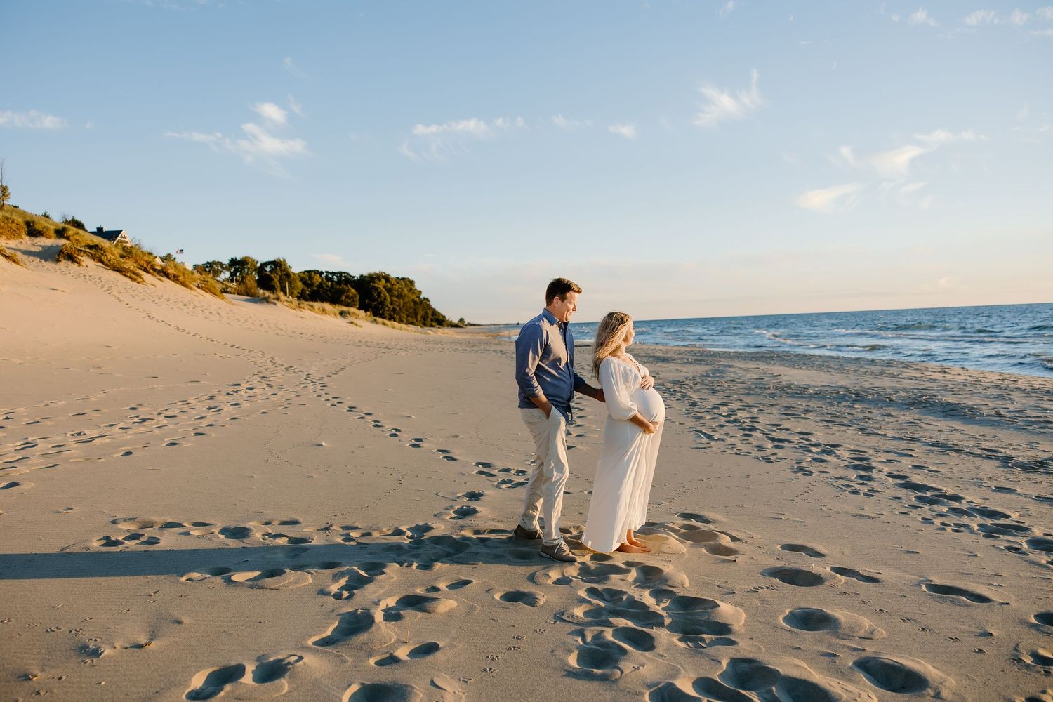Scenic beach photos showing couple walking along shoreline during golden hour.