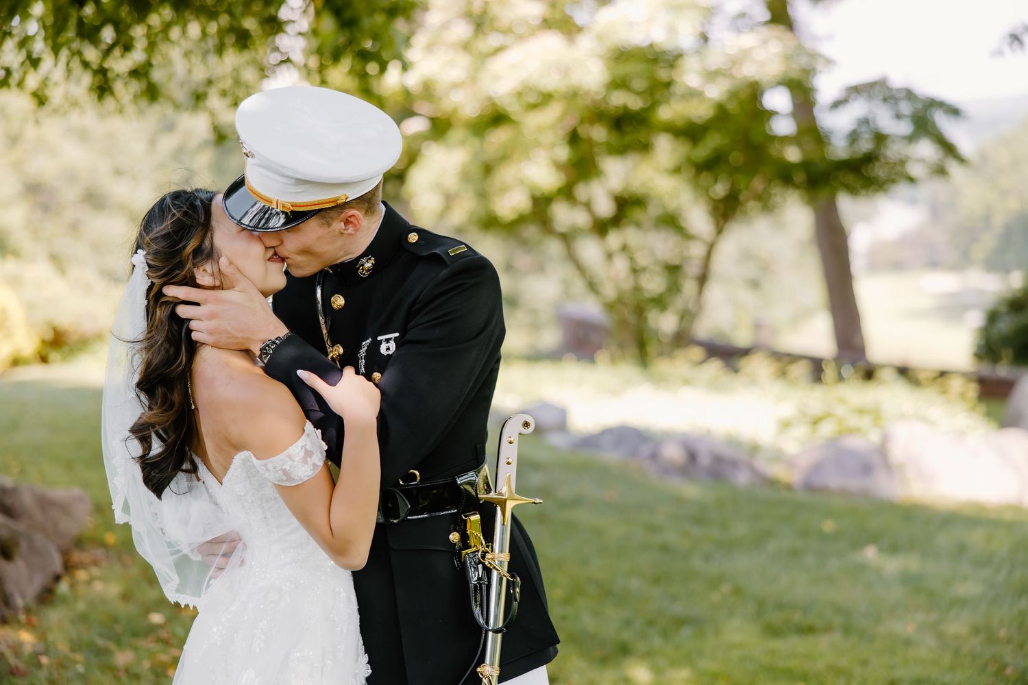 Romantic wedding moment captured in soft natural lighting outdoors.